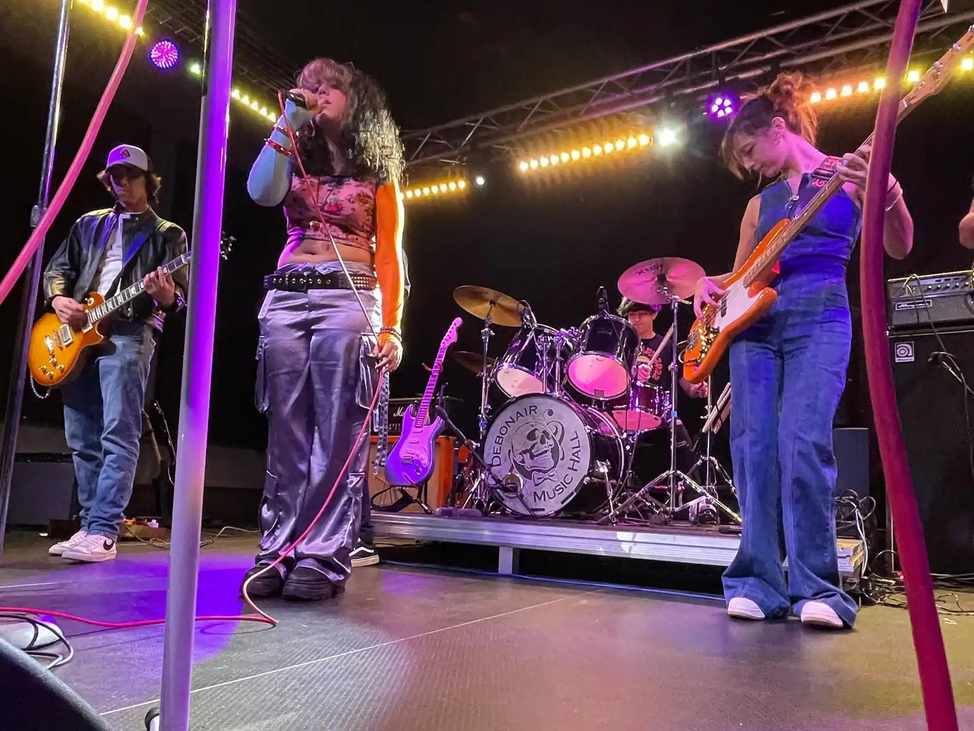 a group of people playing instruments on a stage