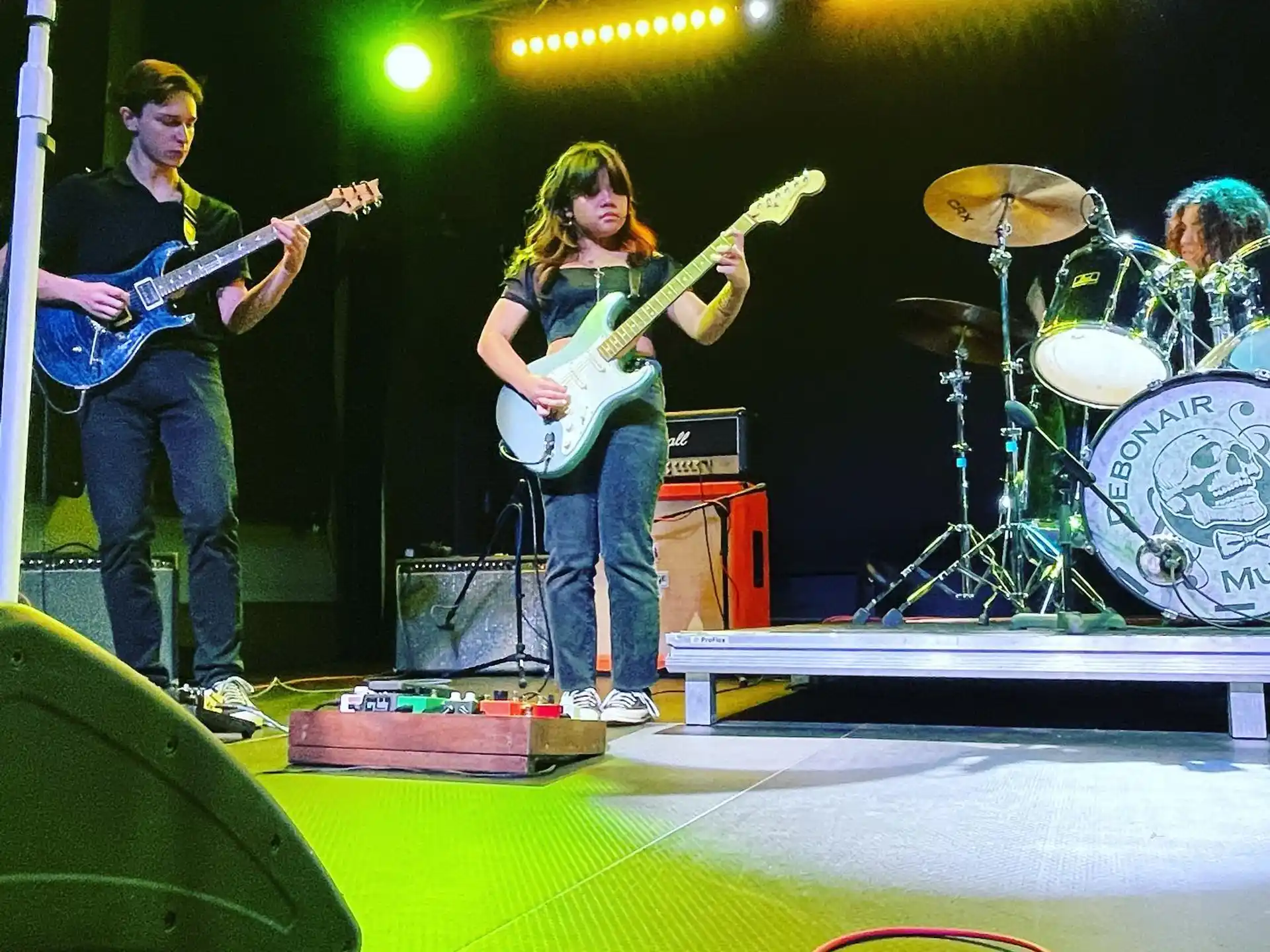 a group of people playing instruments on a stage