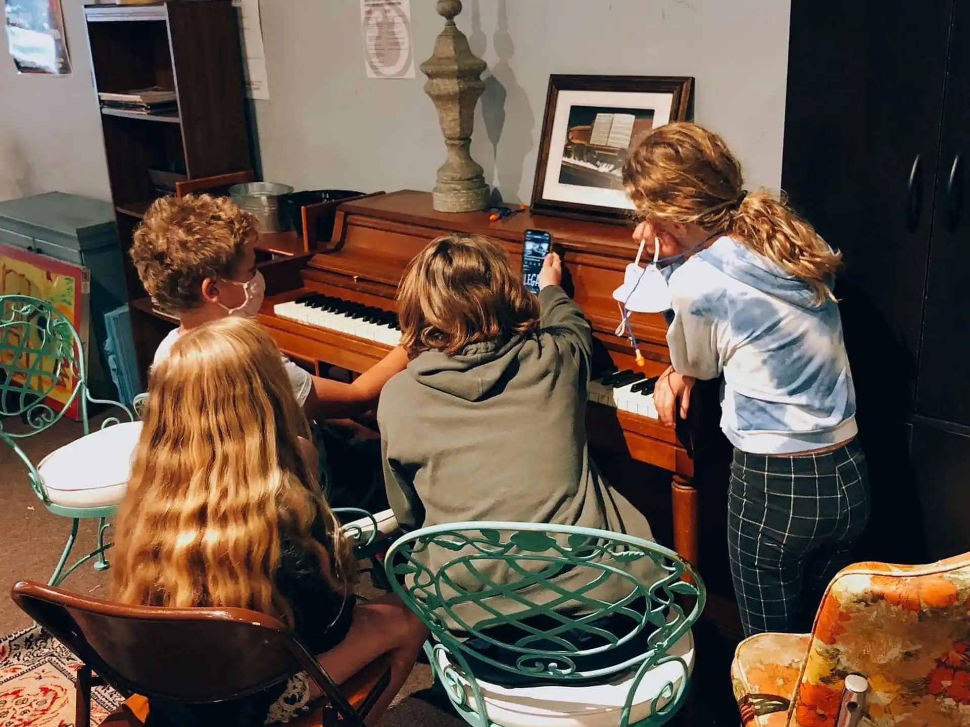 a group of people playing a piano