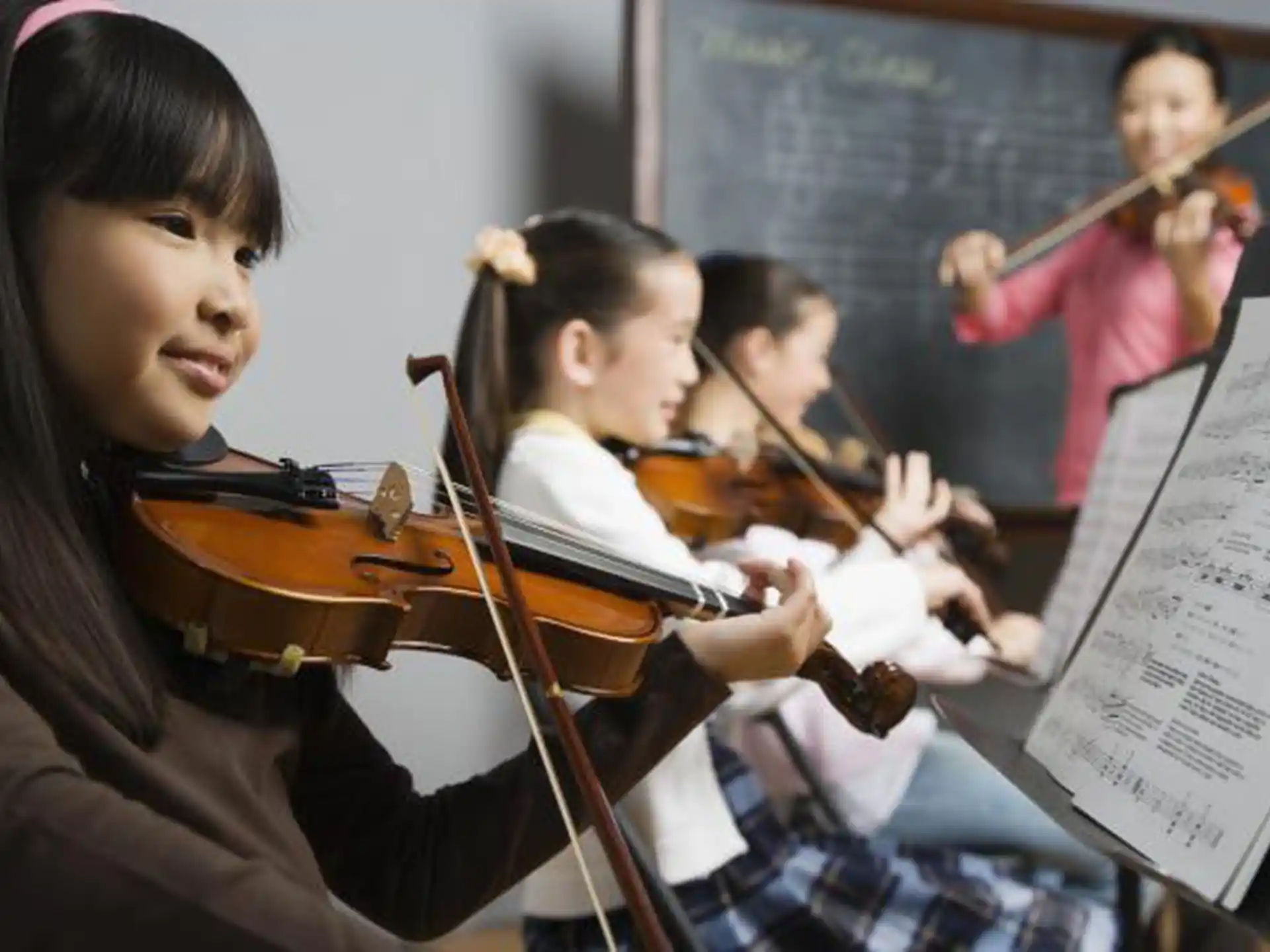 a group of kids playing violin