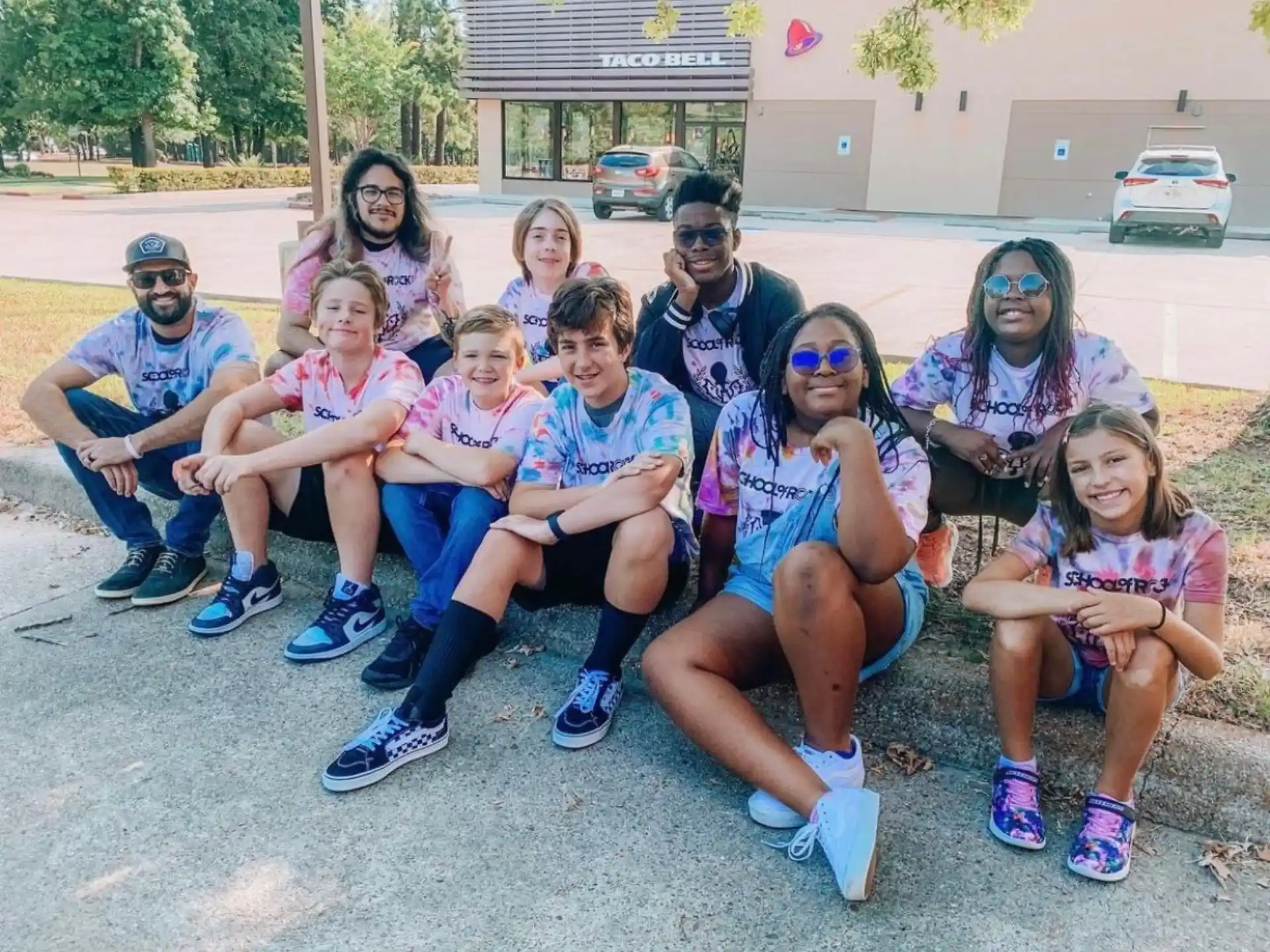 a group of people sitting together outside