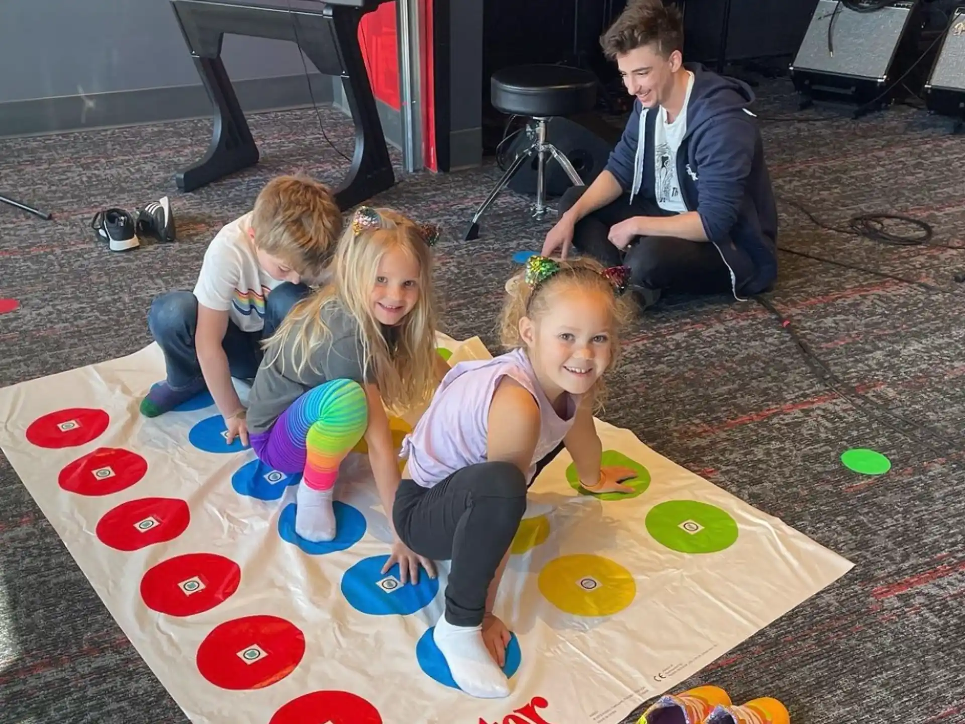 a group of children playing on a wooden floor