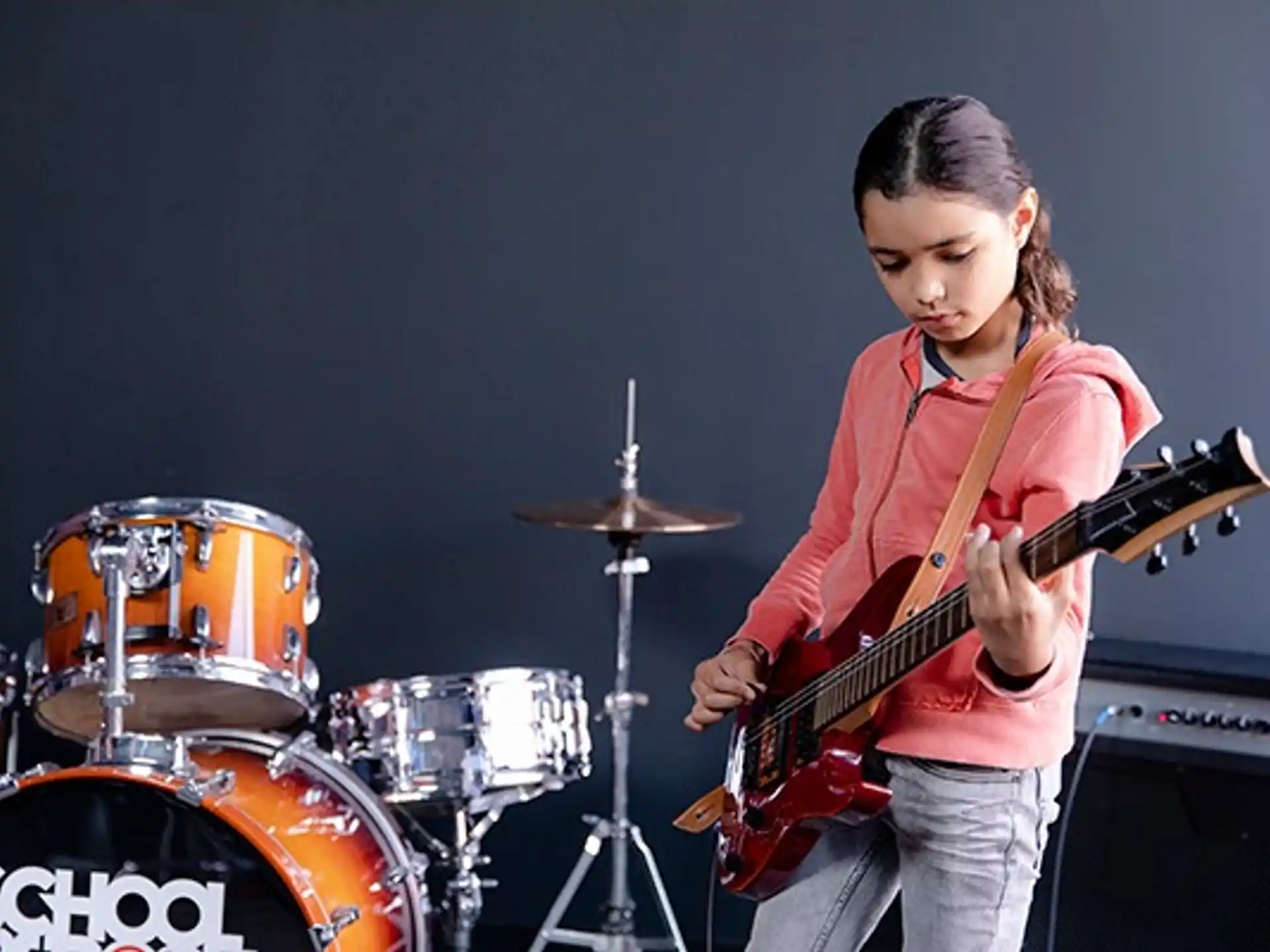 a girl playing a guitar