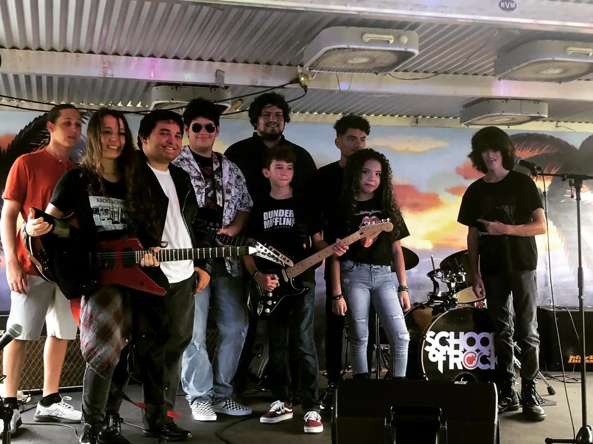 a group of people standing on a stage with musical instruments