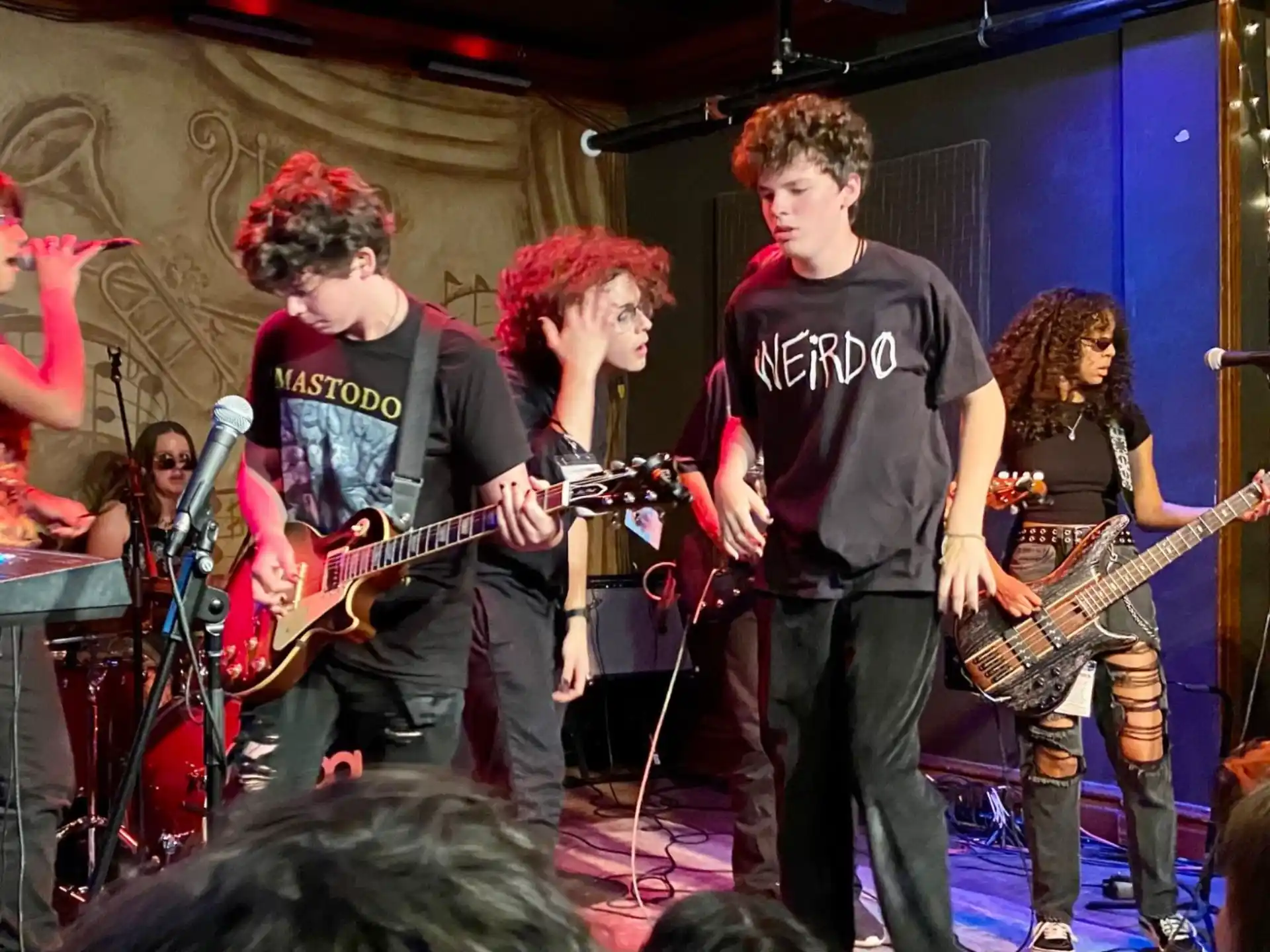 a group of people playing instruments on a stage