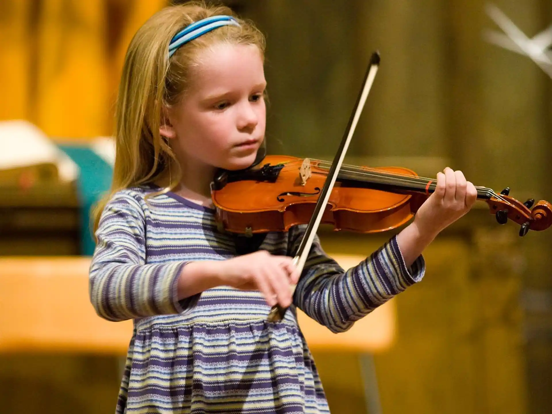 a girl playing a violin