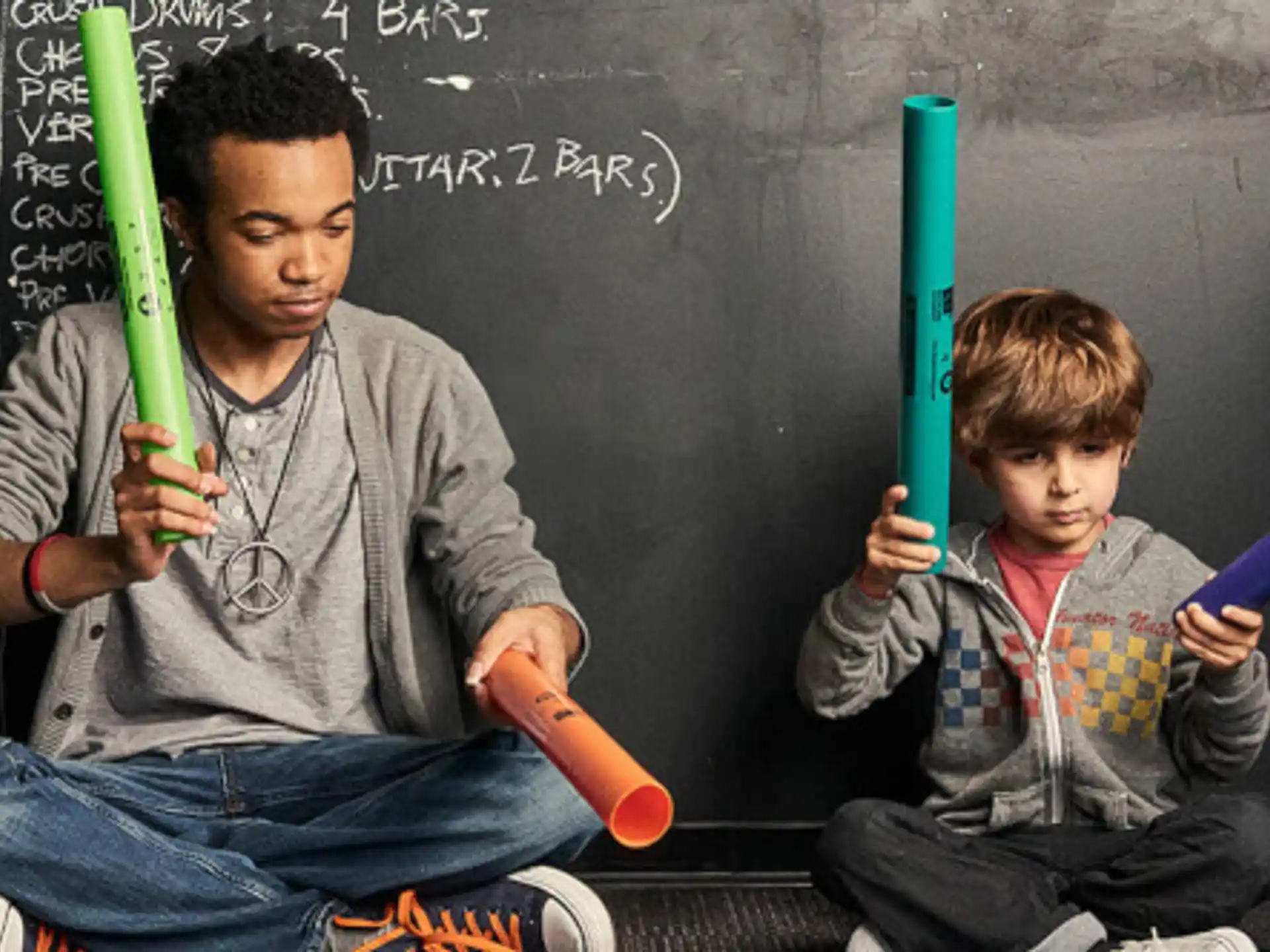 a man and a boy holding baseball bats
