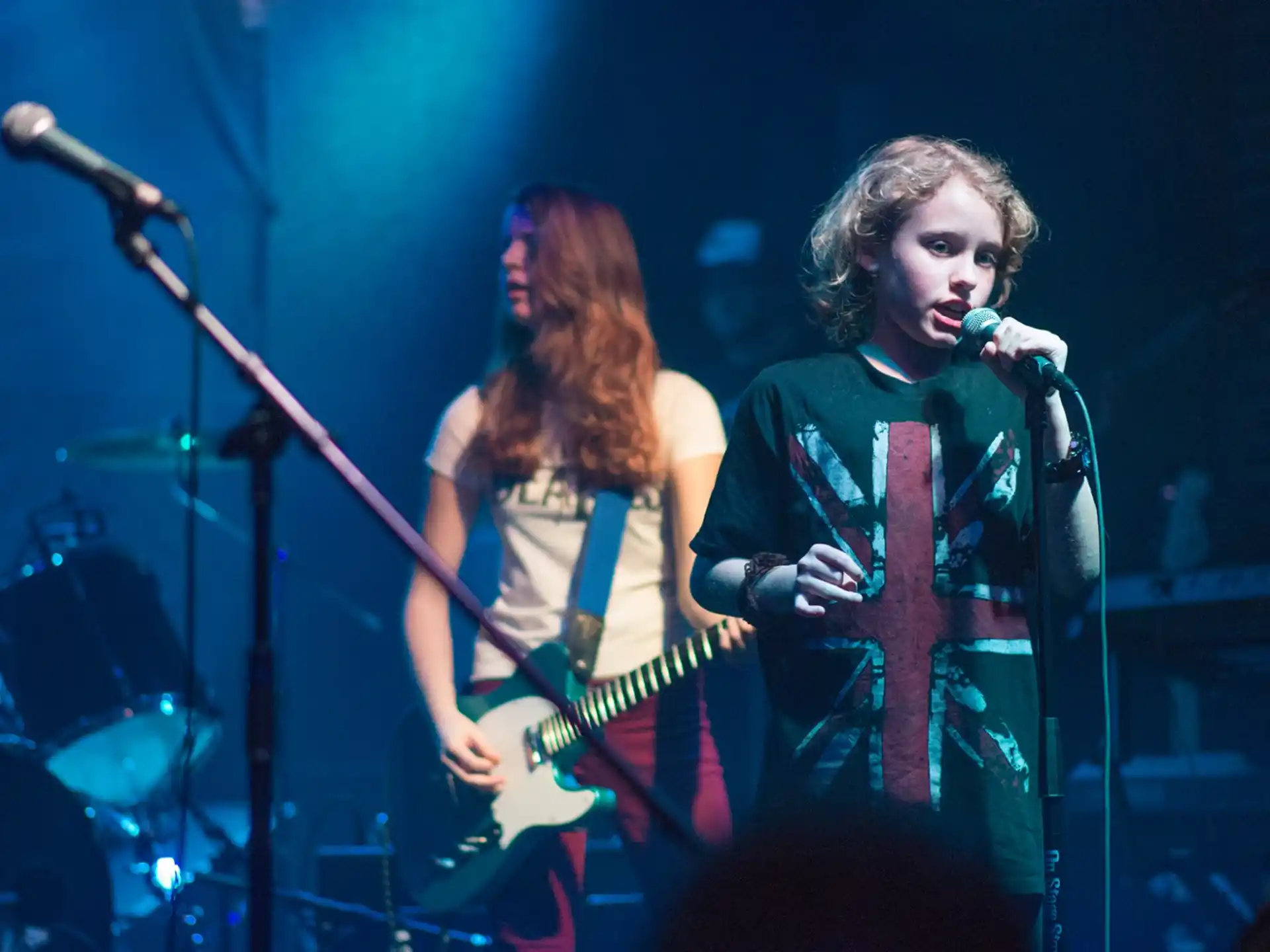 a man and woman singing on stage
