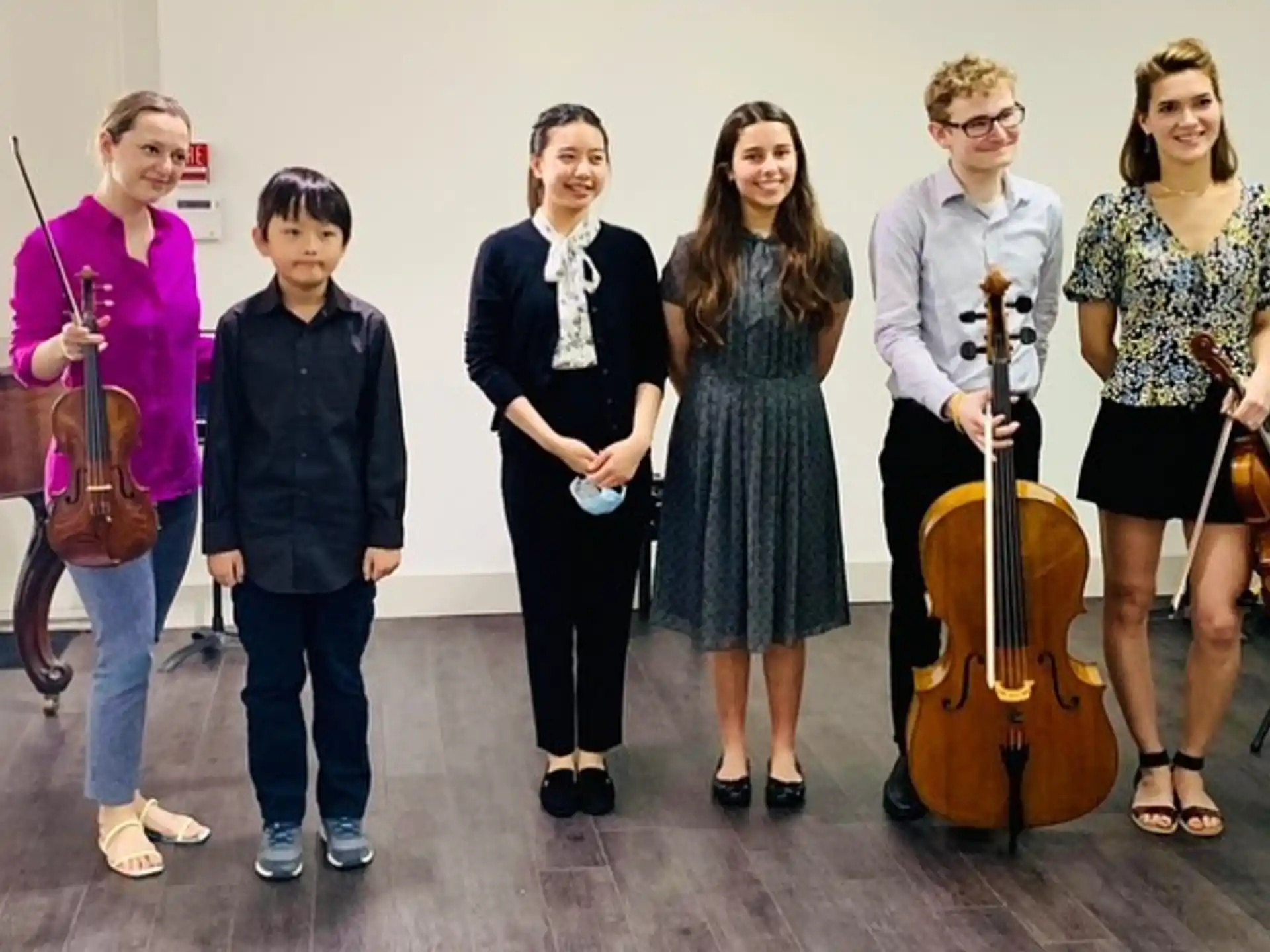 a group of people holding musical instruments