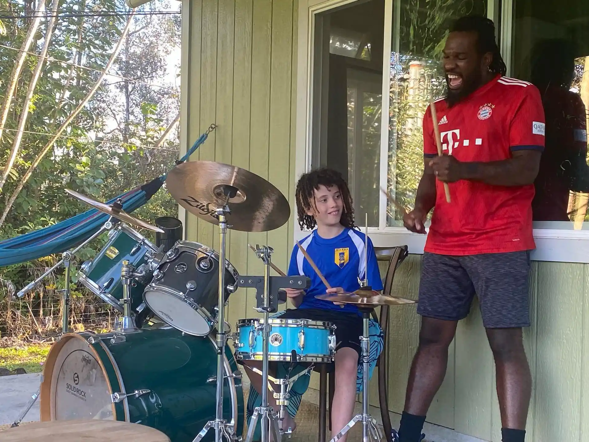 a person and a girl playing drums