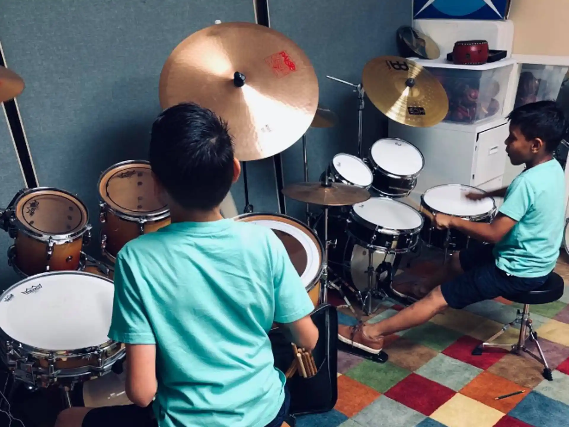 a couple of boys playing drums