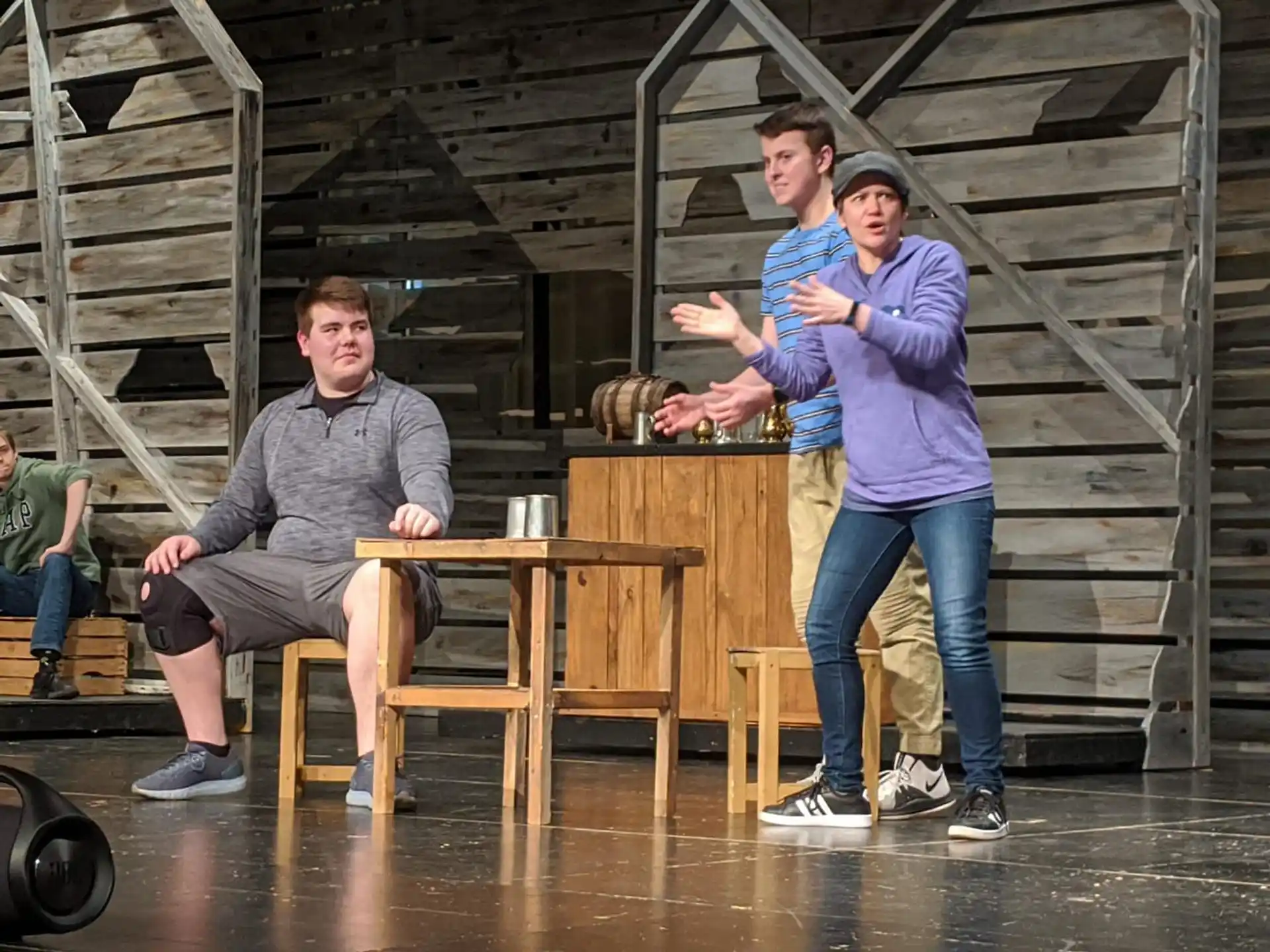 a group of men sitting at a table in a warehouse