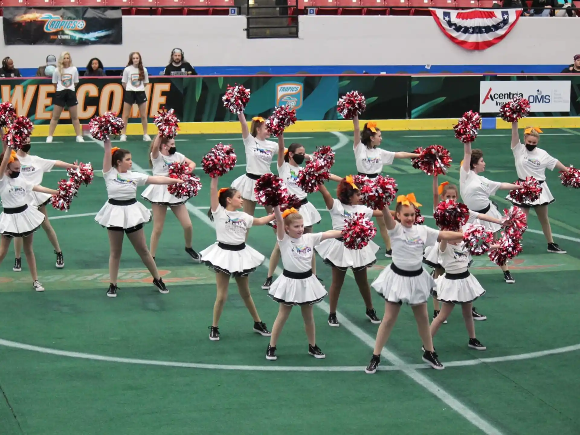 a group of cheerleaders on a football field