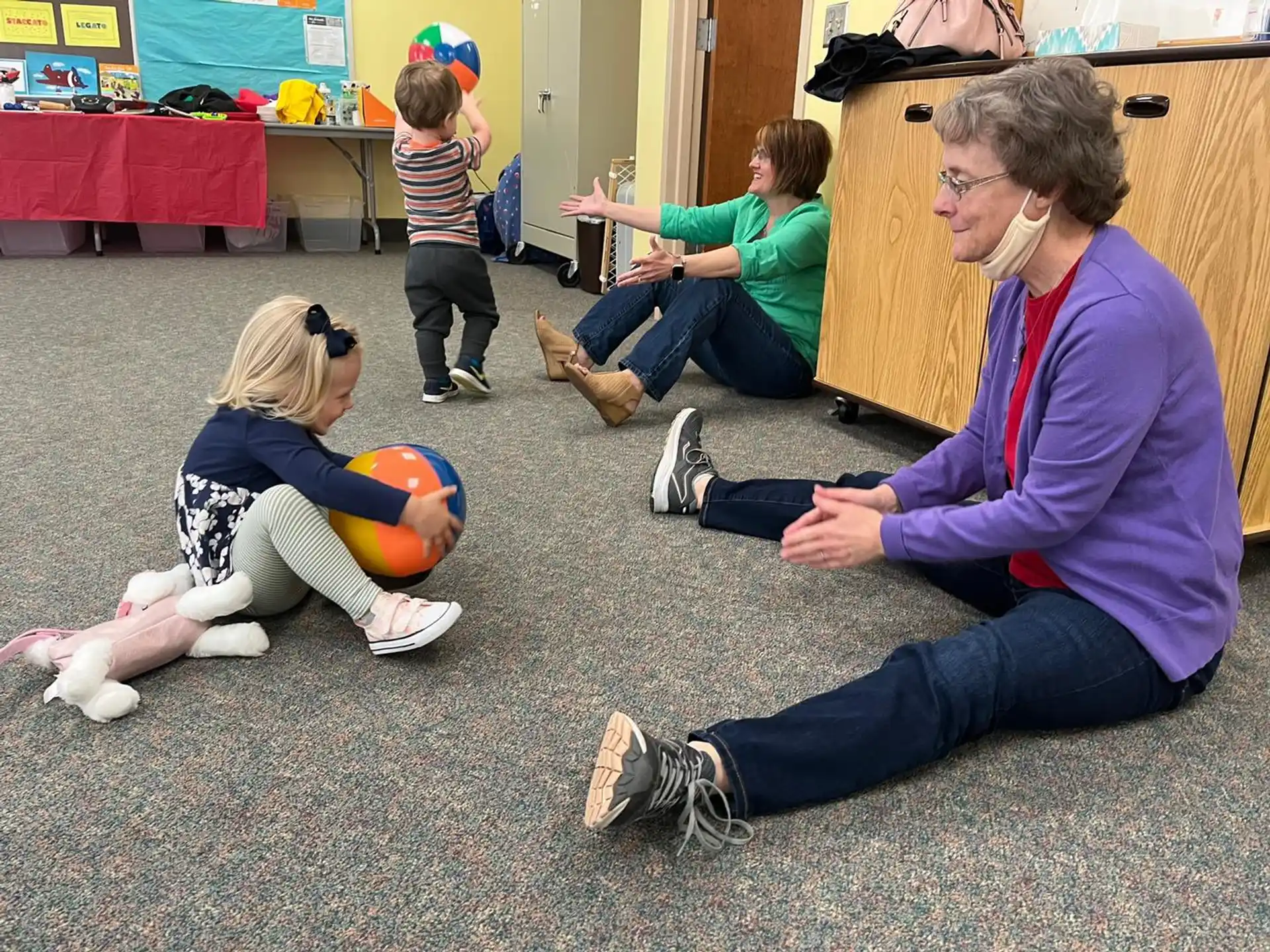 a person and a child playing with a ball