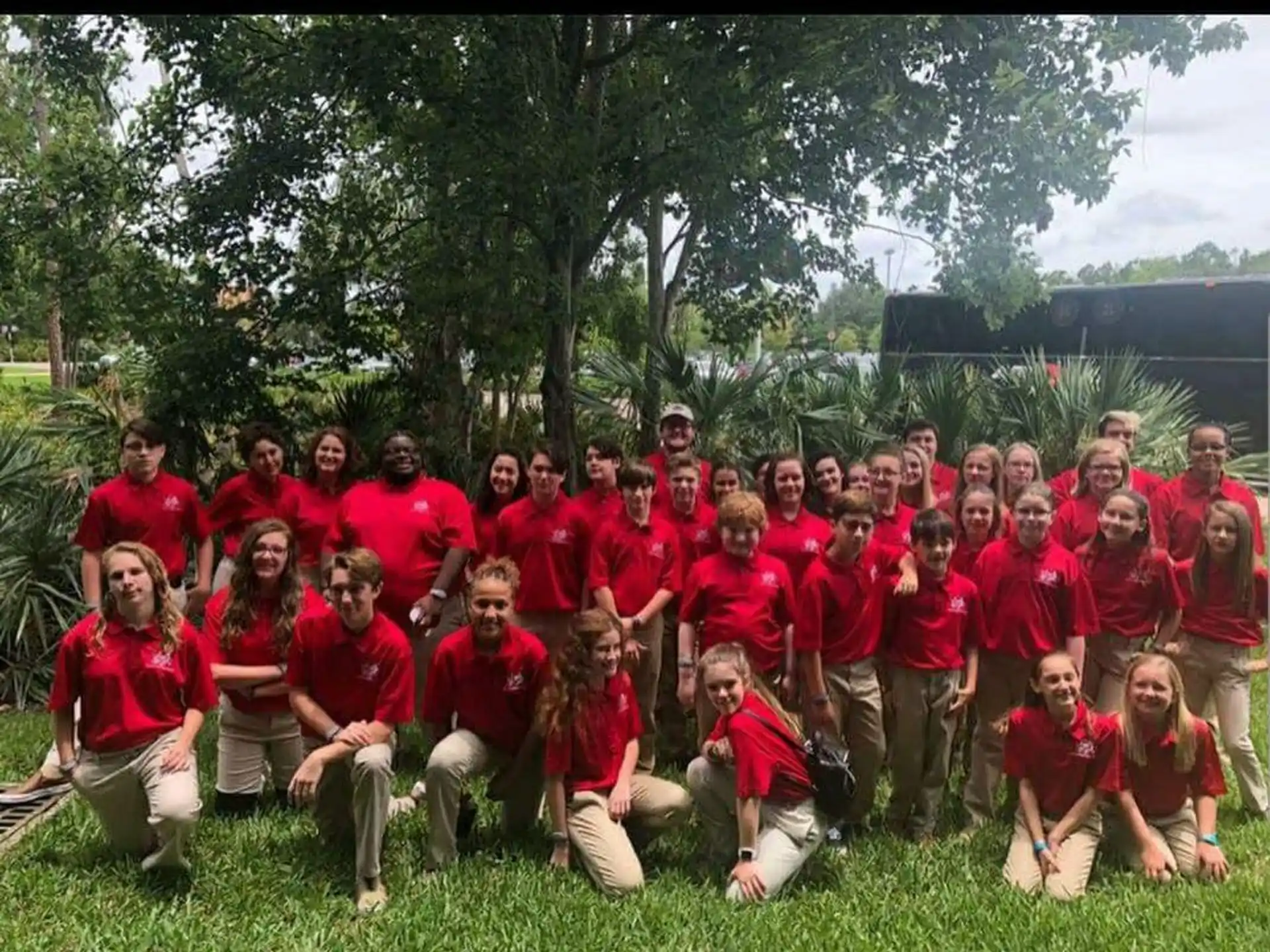 a group of people wearing red shirts