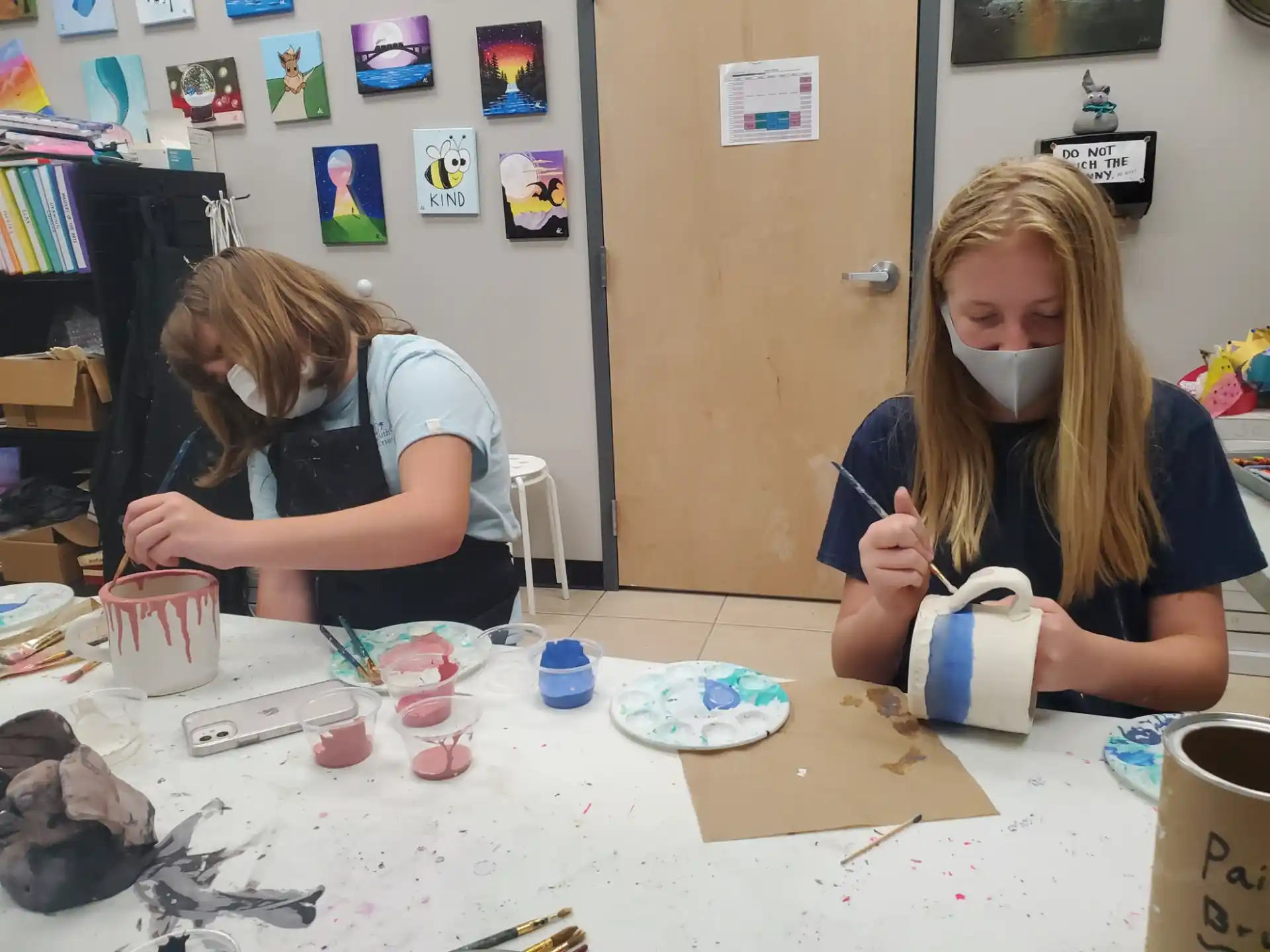 a couple of girls painting