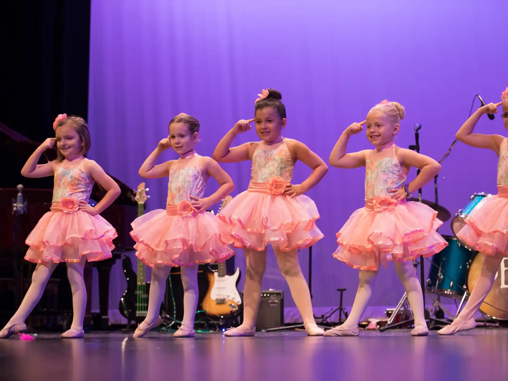 a group of girls performing on a stage