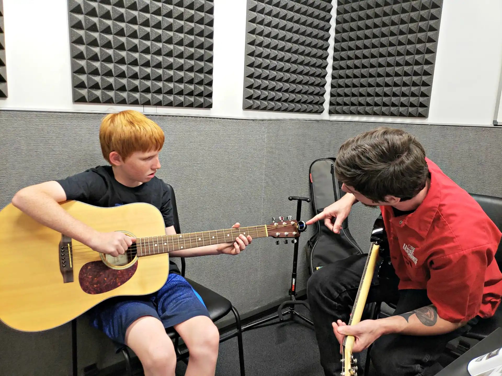 two boys playing guitars