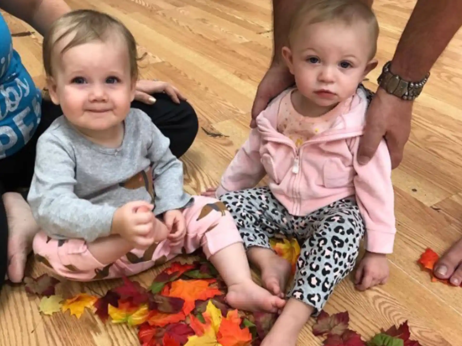 a couple of babies sitting on the floor