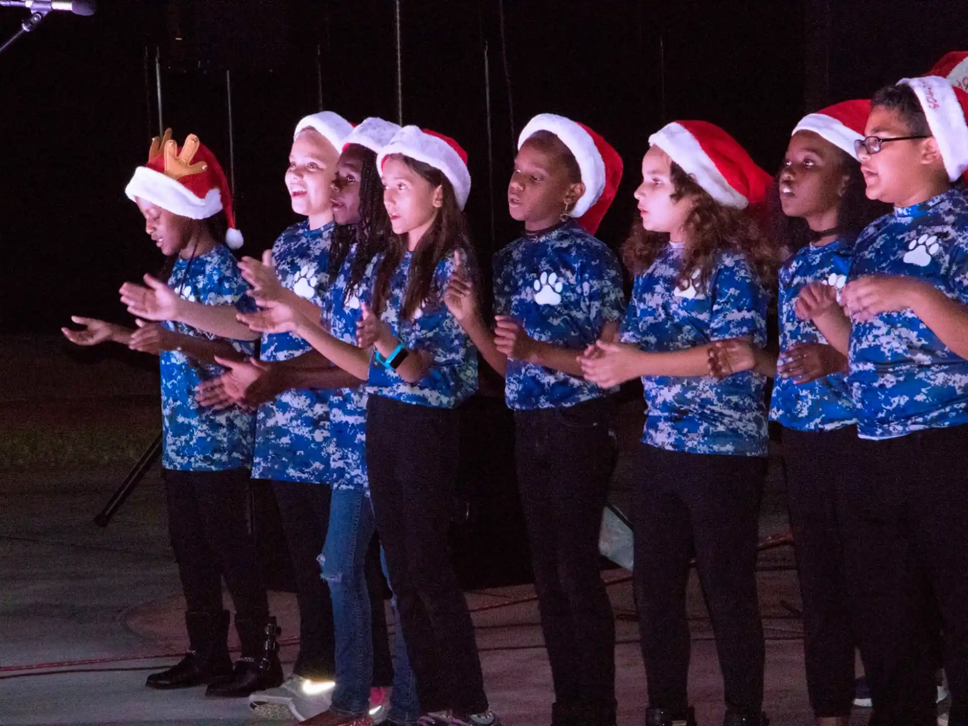 a group of people wearing christmas hats