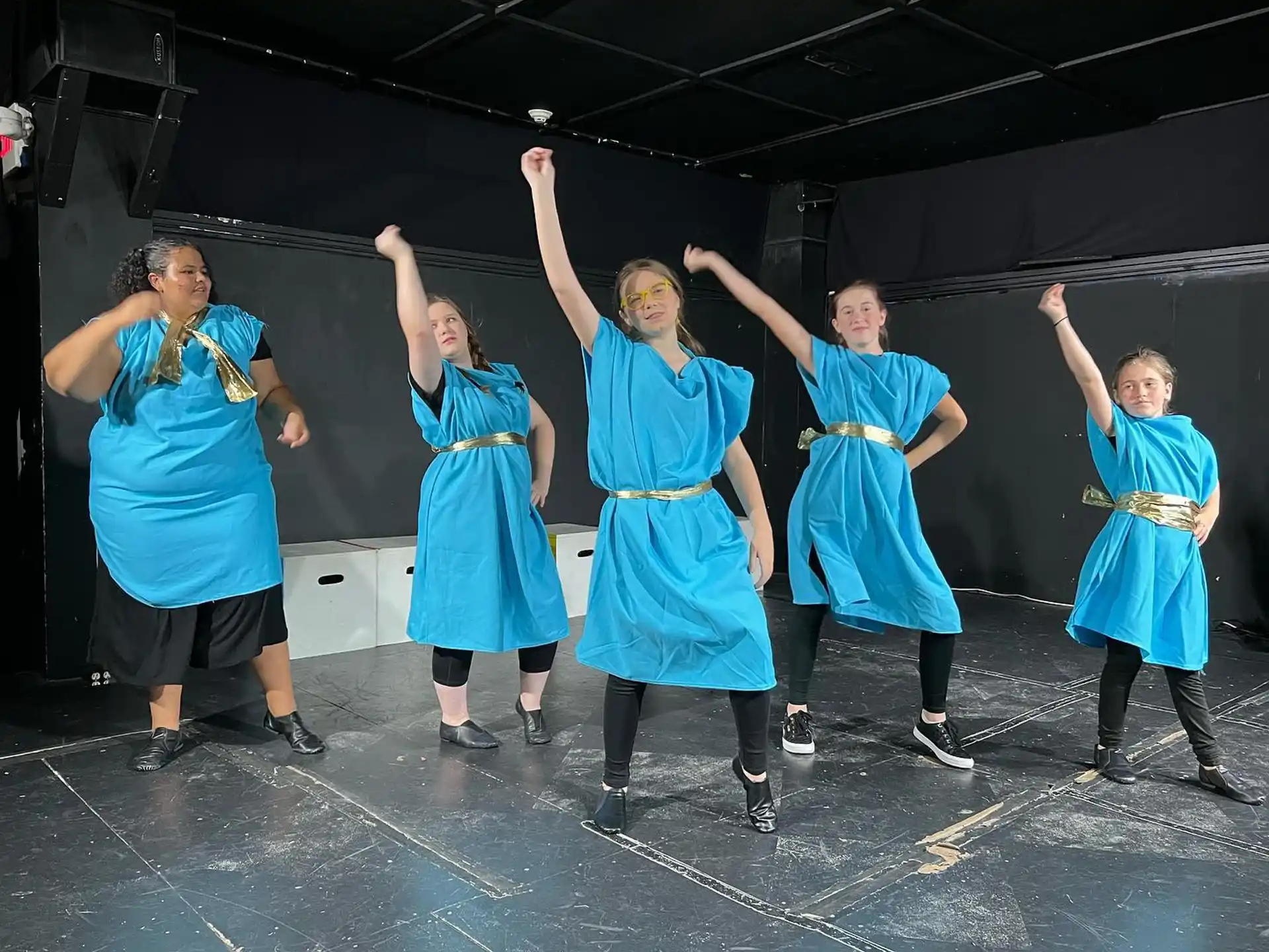 a group of women in blue dresses