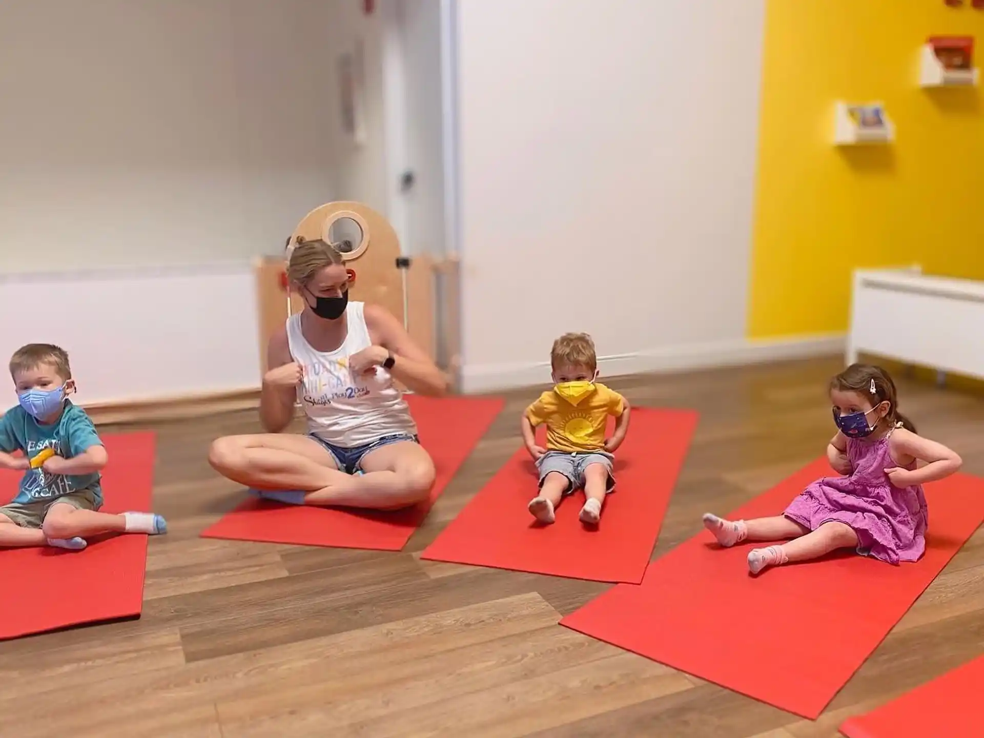 a group of children sitting on mats