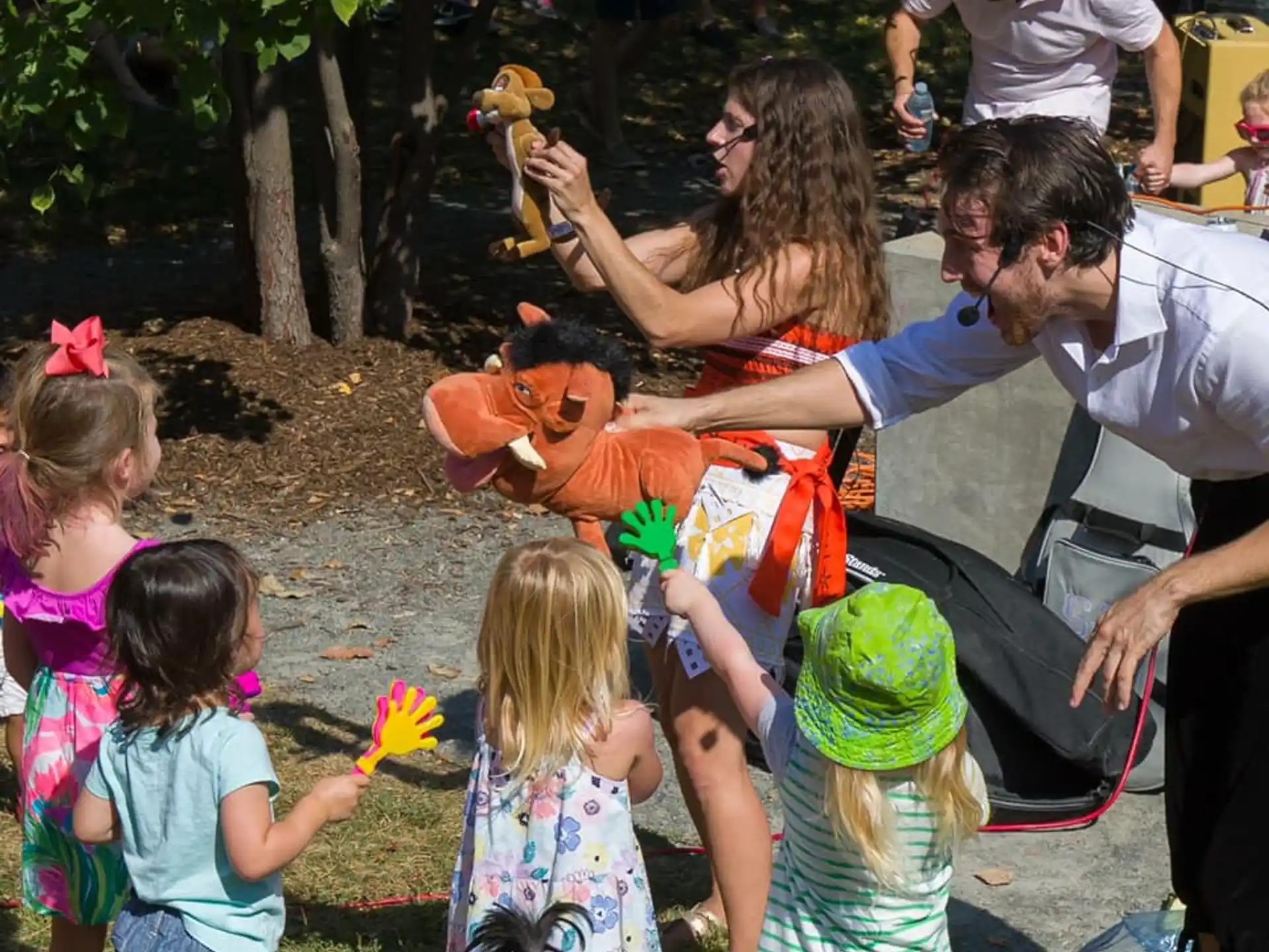 a man and woman feeding a baby