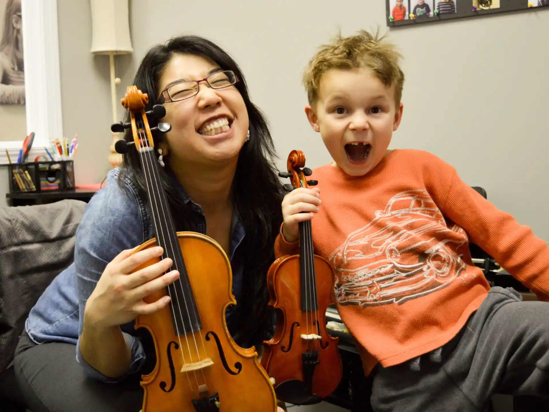 a boy and a girl playing the violin