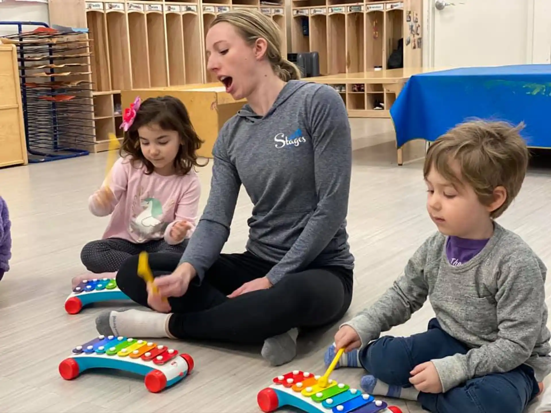 a woman and kids playing with toys