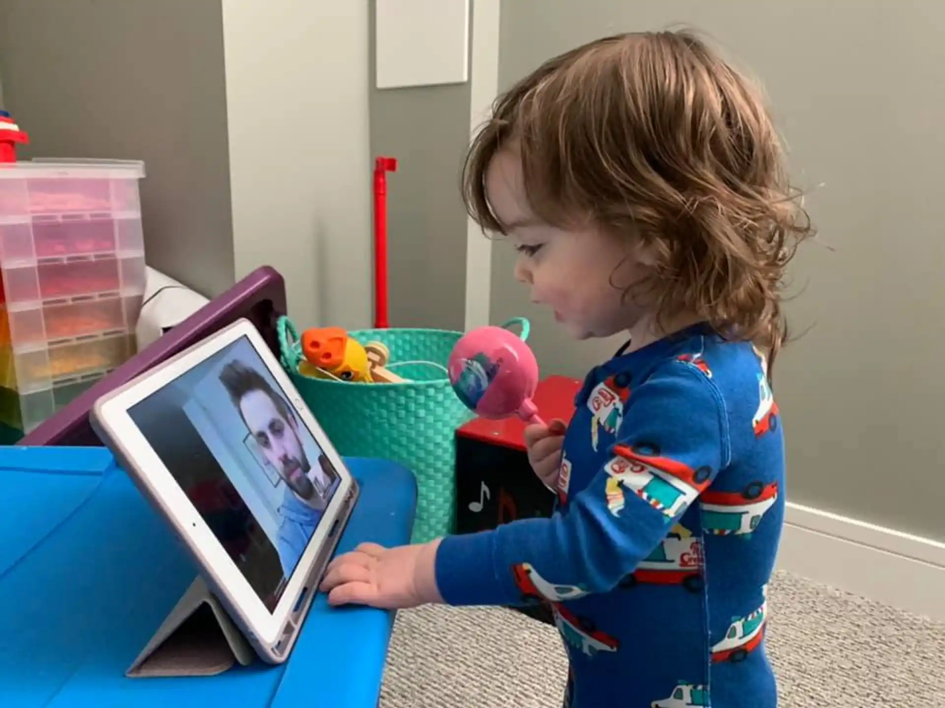 a young girl playing with a tablet