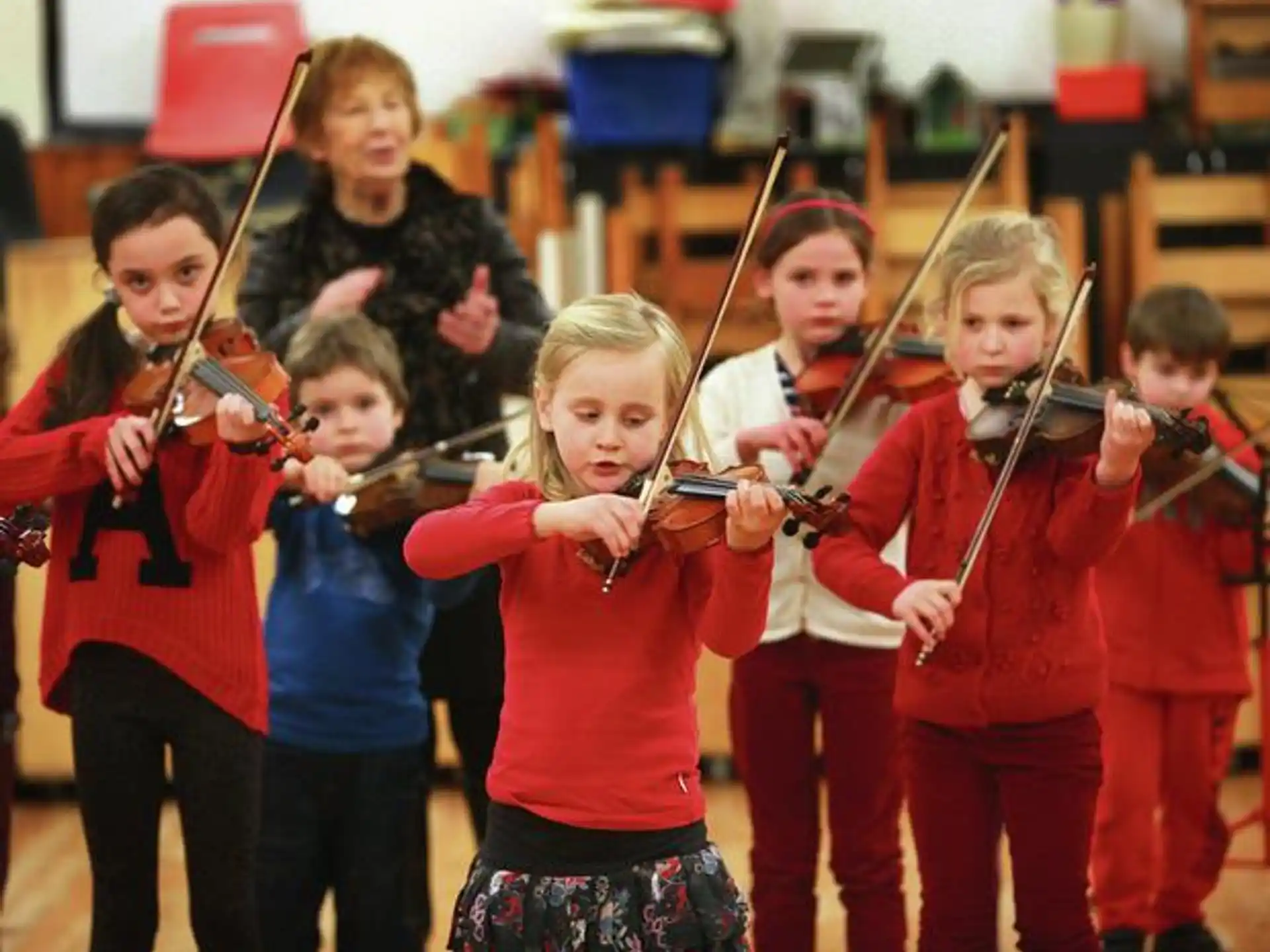 a group of kids playing instruments