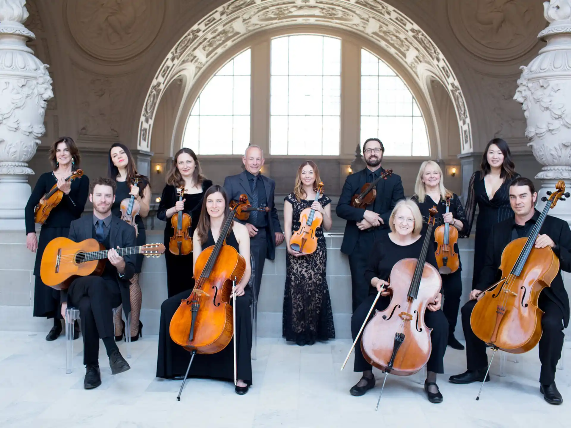 a group of people holding musical instruments