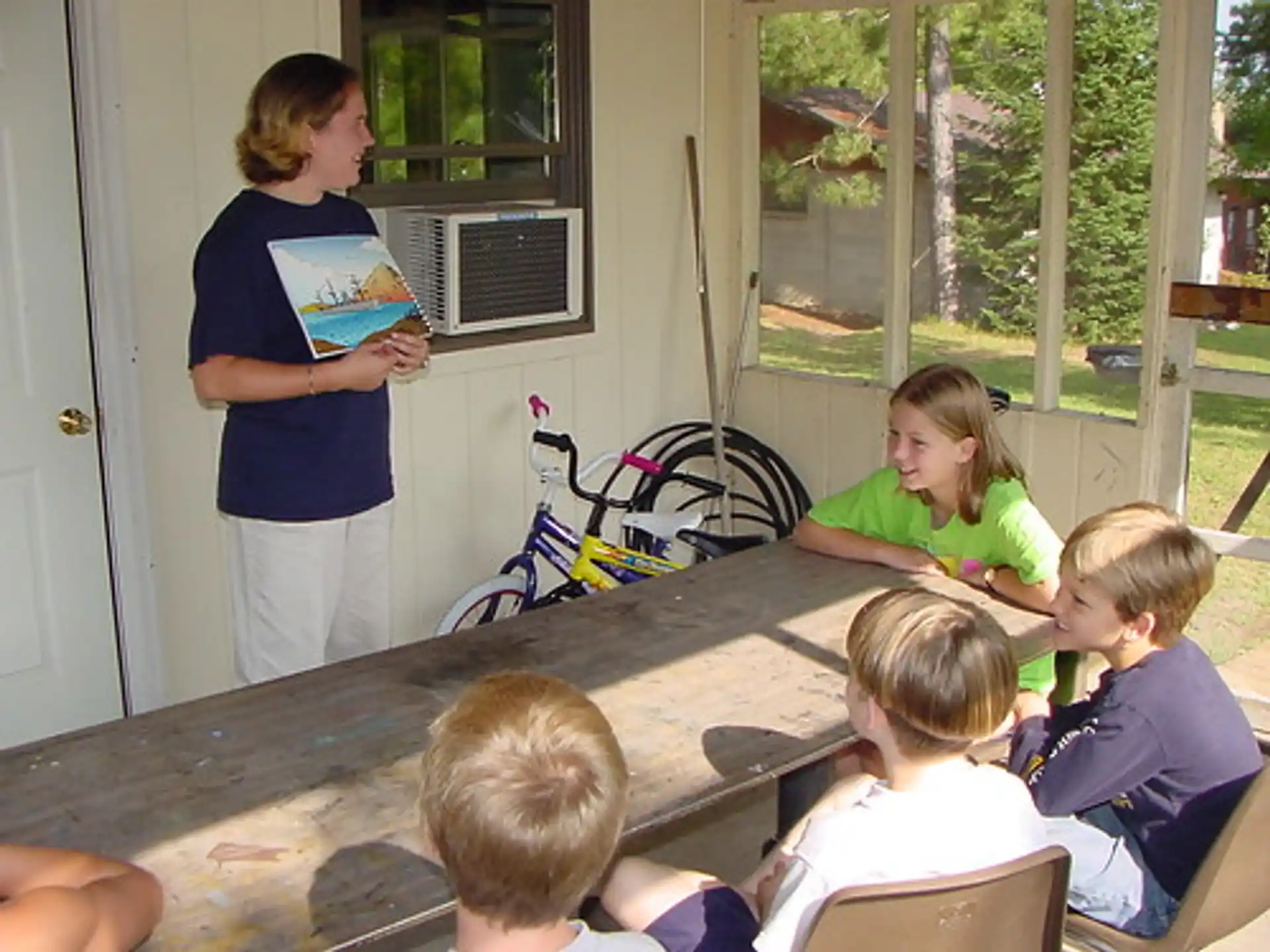 a group of children sitting around a table