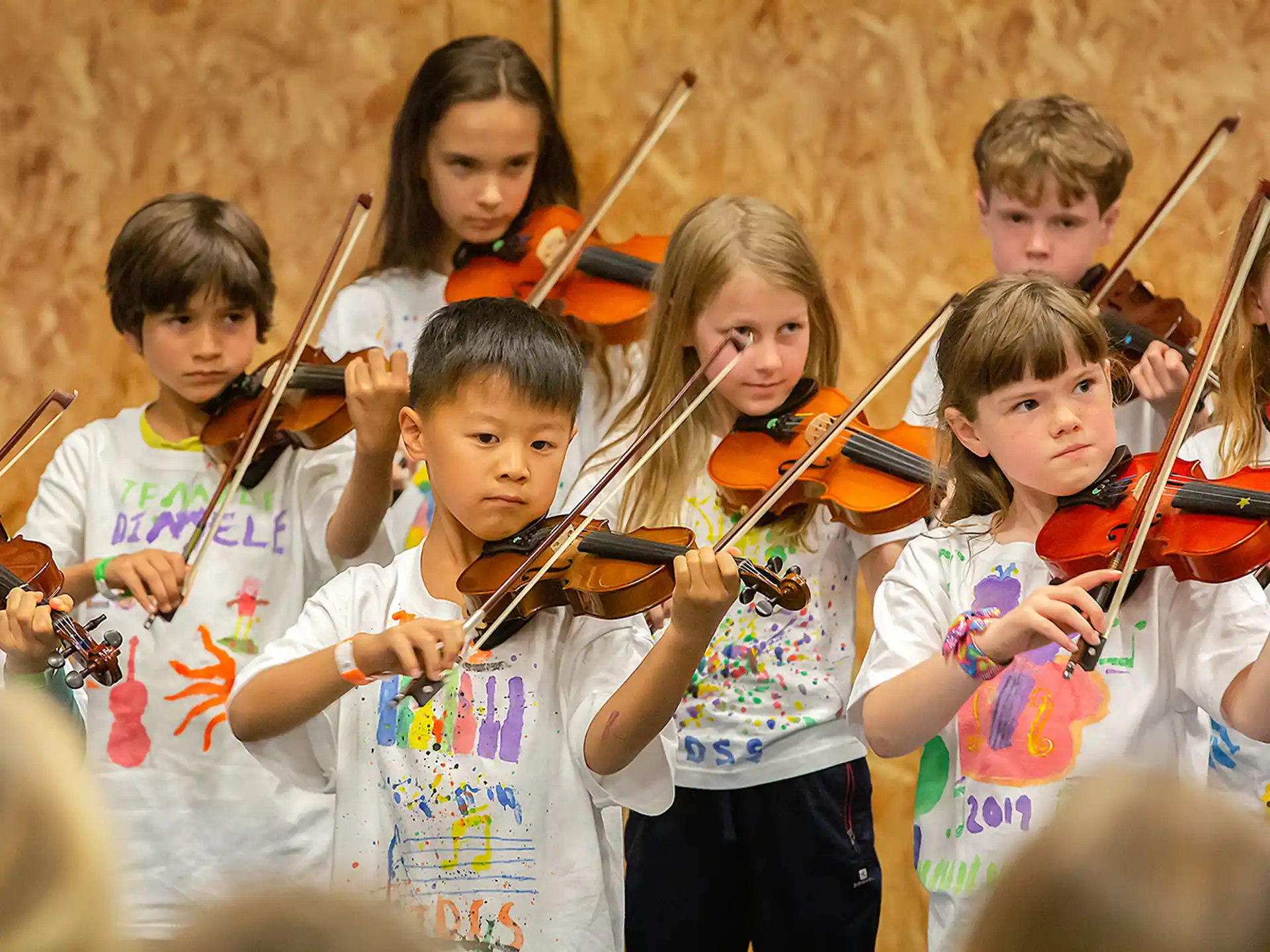 a group of children holding sticks