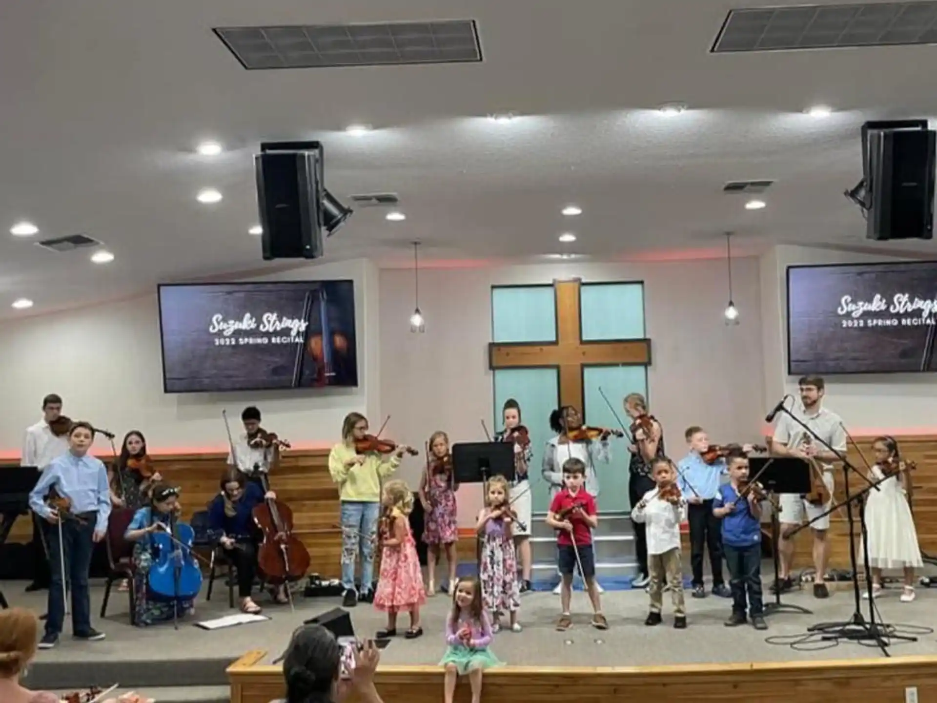 a group of children performing on a stage