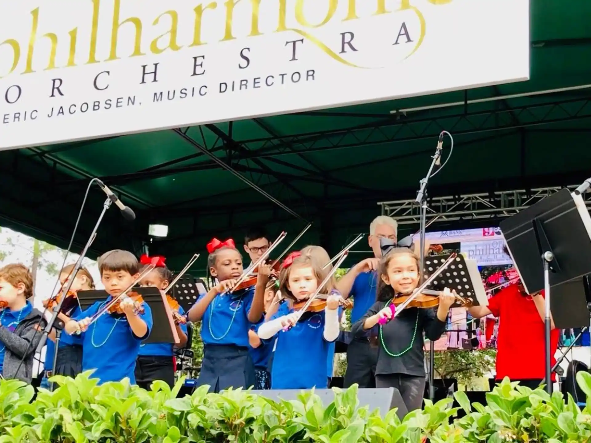 a group of children holding musical instruments