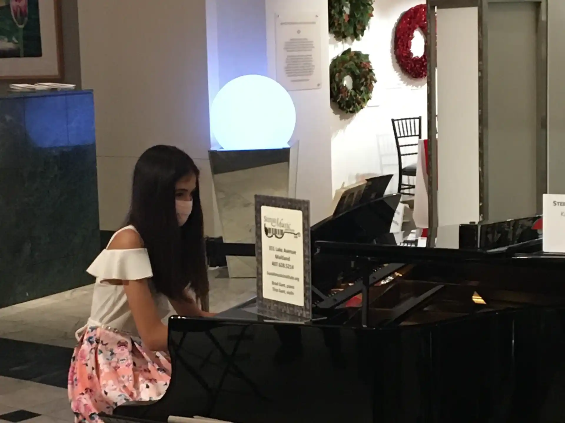 a woman sitting on a piano