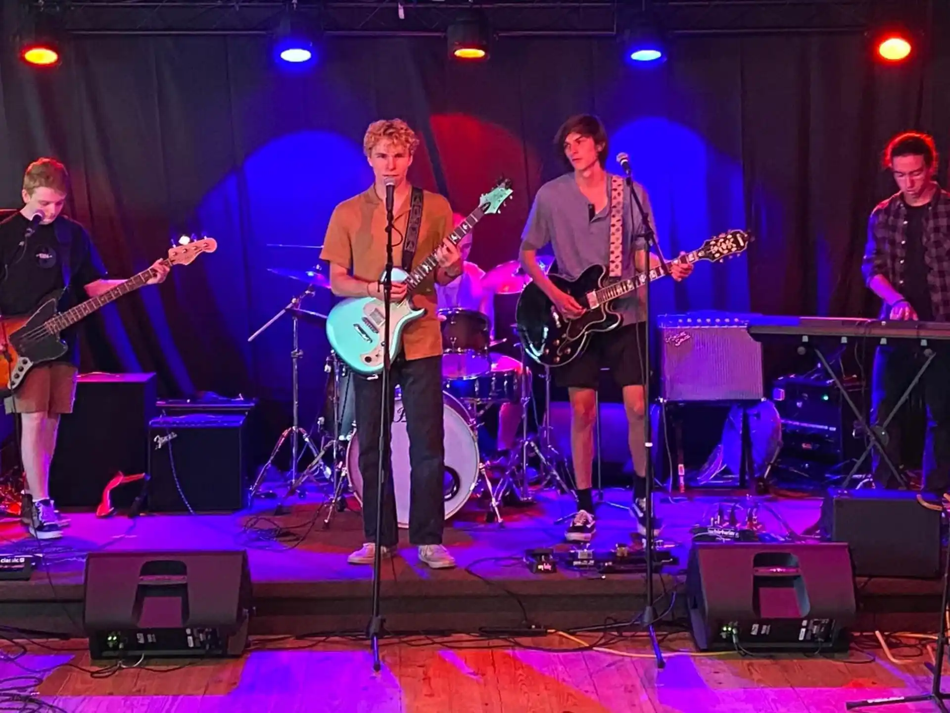 a group of people playing instruments on a stage