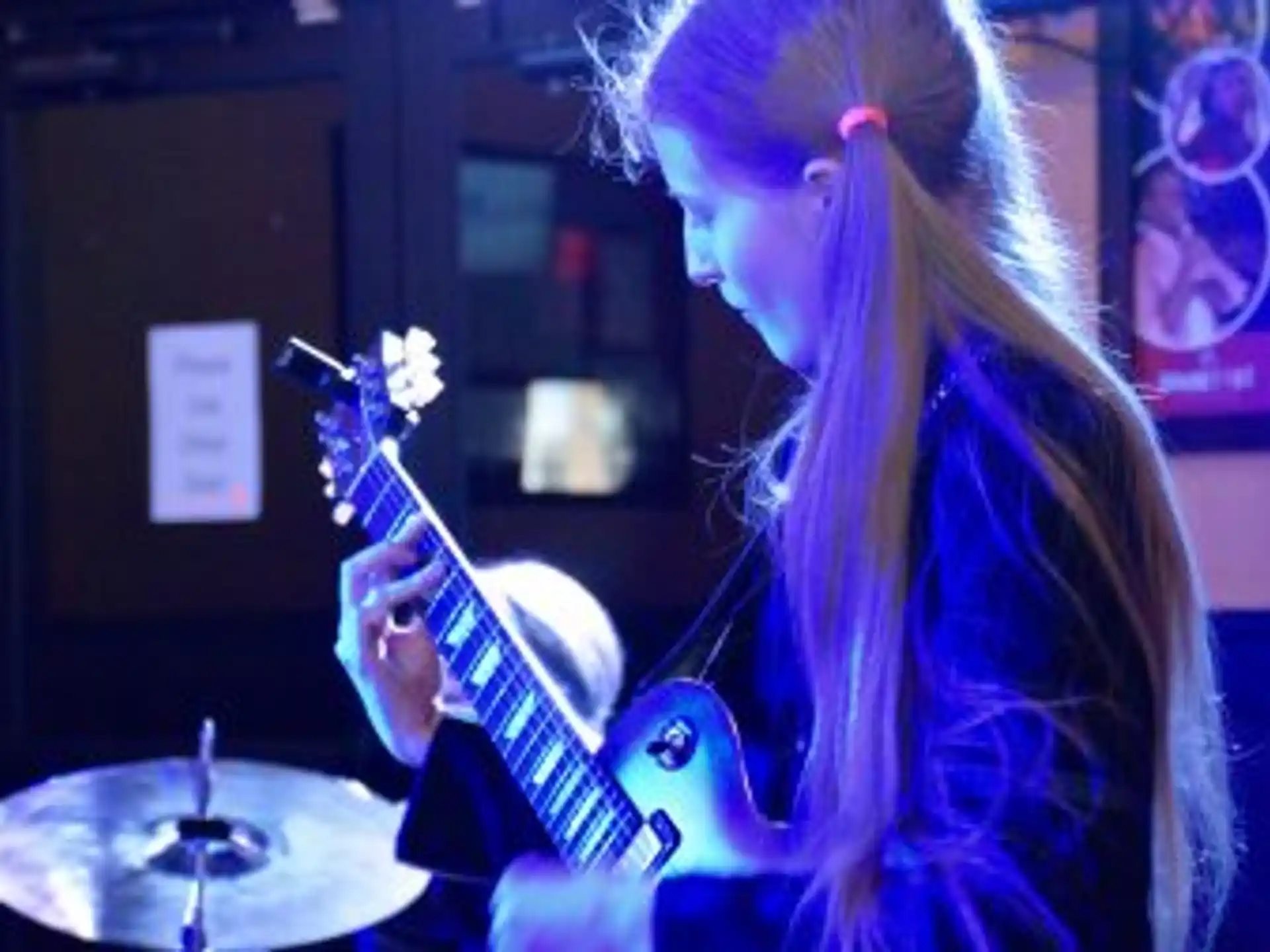 a woman playing a guitar