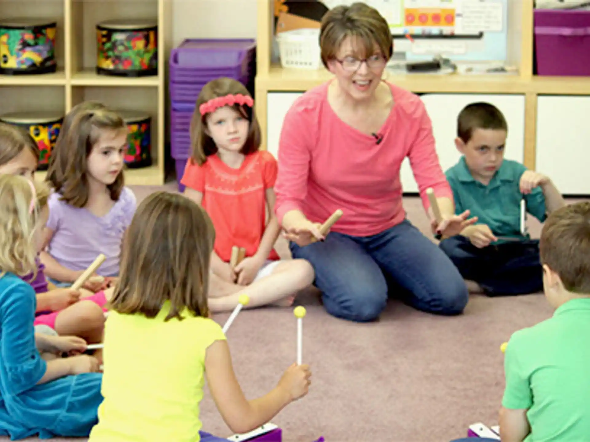 a person and several children sitting in a room