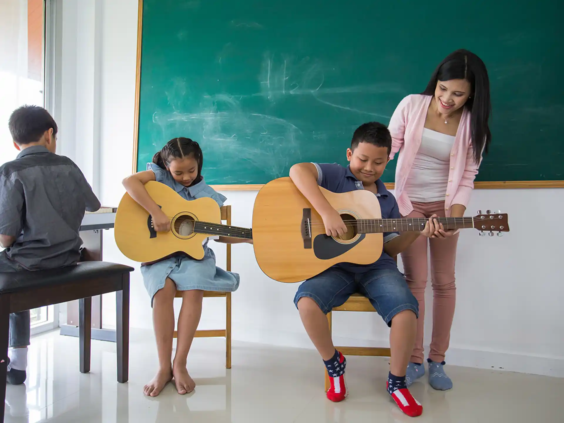a group of kids playing a guitar