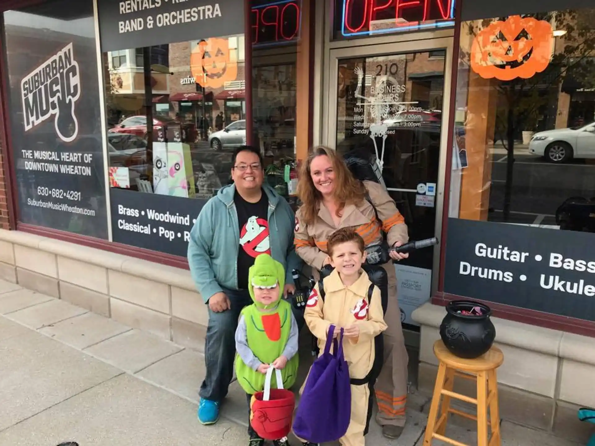 a group of people posing for a photo outside a store