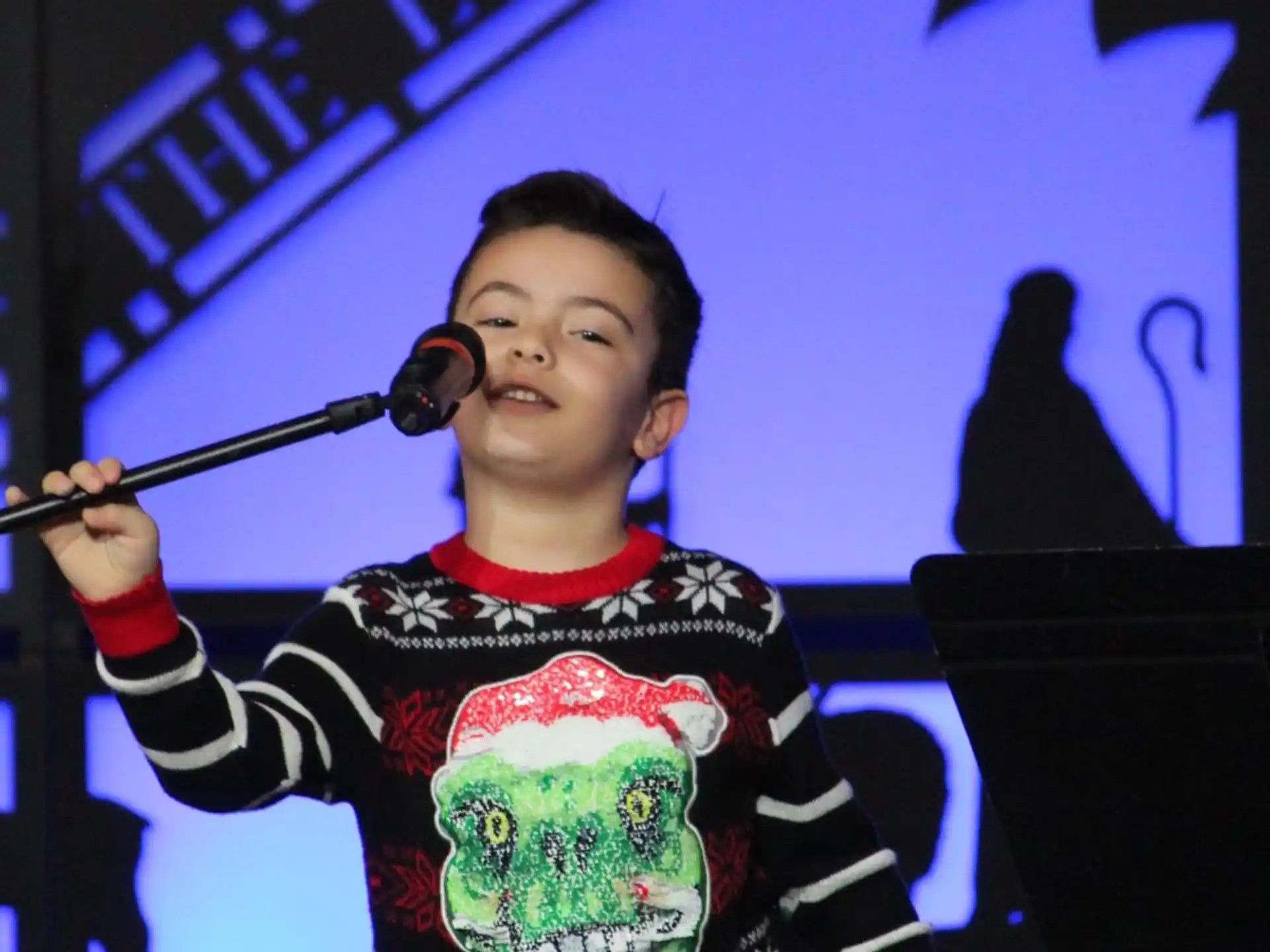a boy holding a microphone