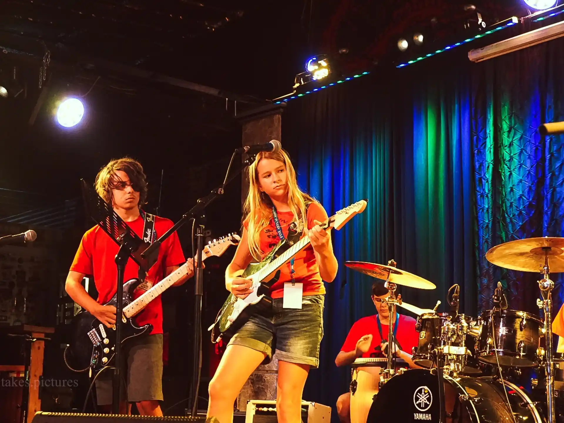 a group of people playing instruments on a stage