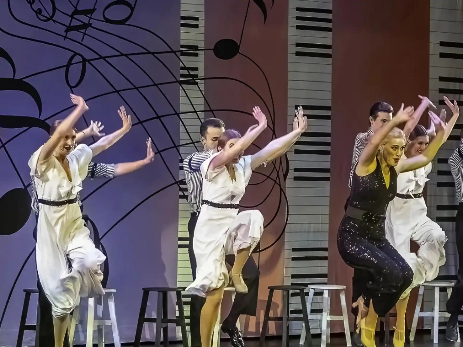 a group of people dancing on a stage