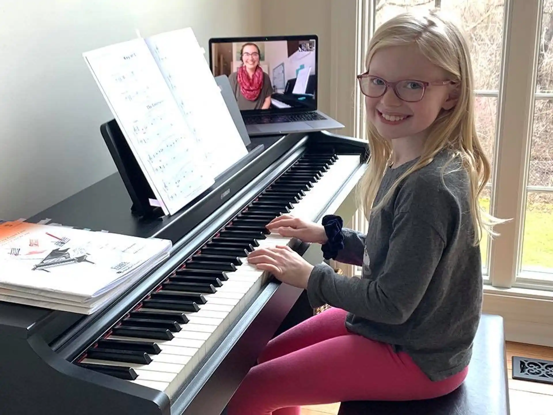 a girl sitting at a piano
