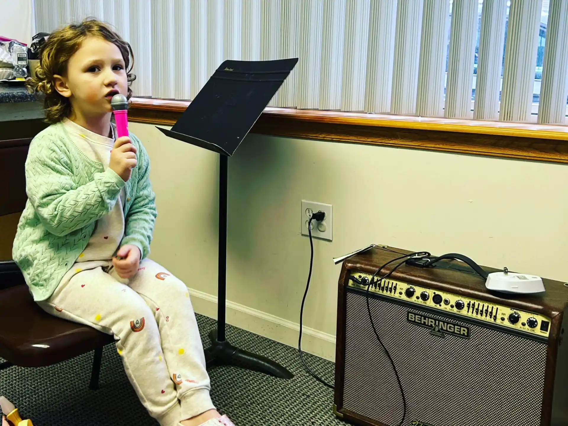 a person sitting on a chair with a microphone in front of the