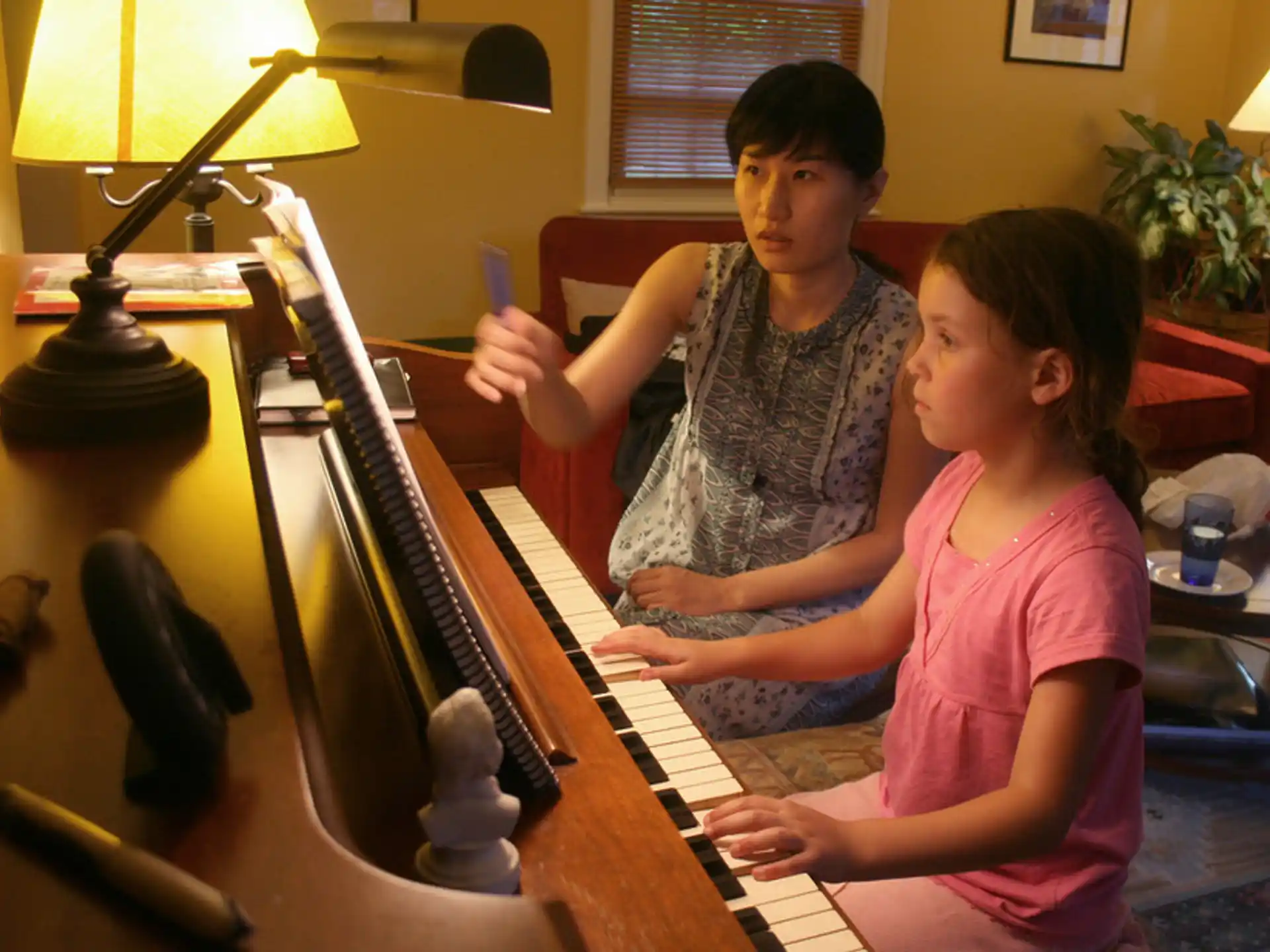 a couple of kids playing piano