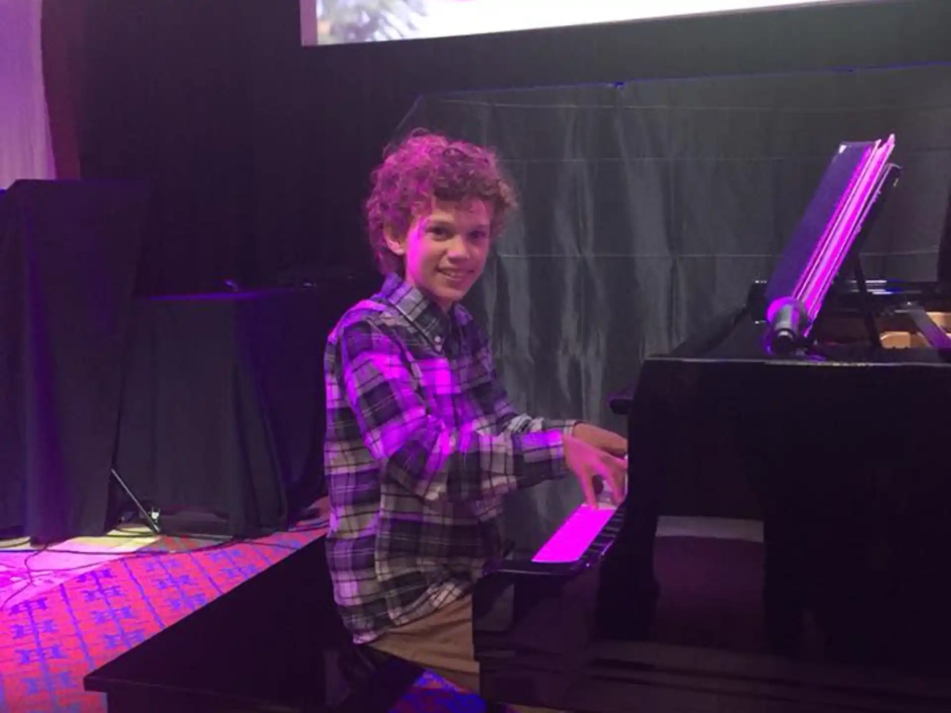 a person sitting at a piano
