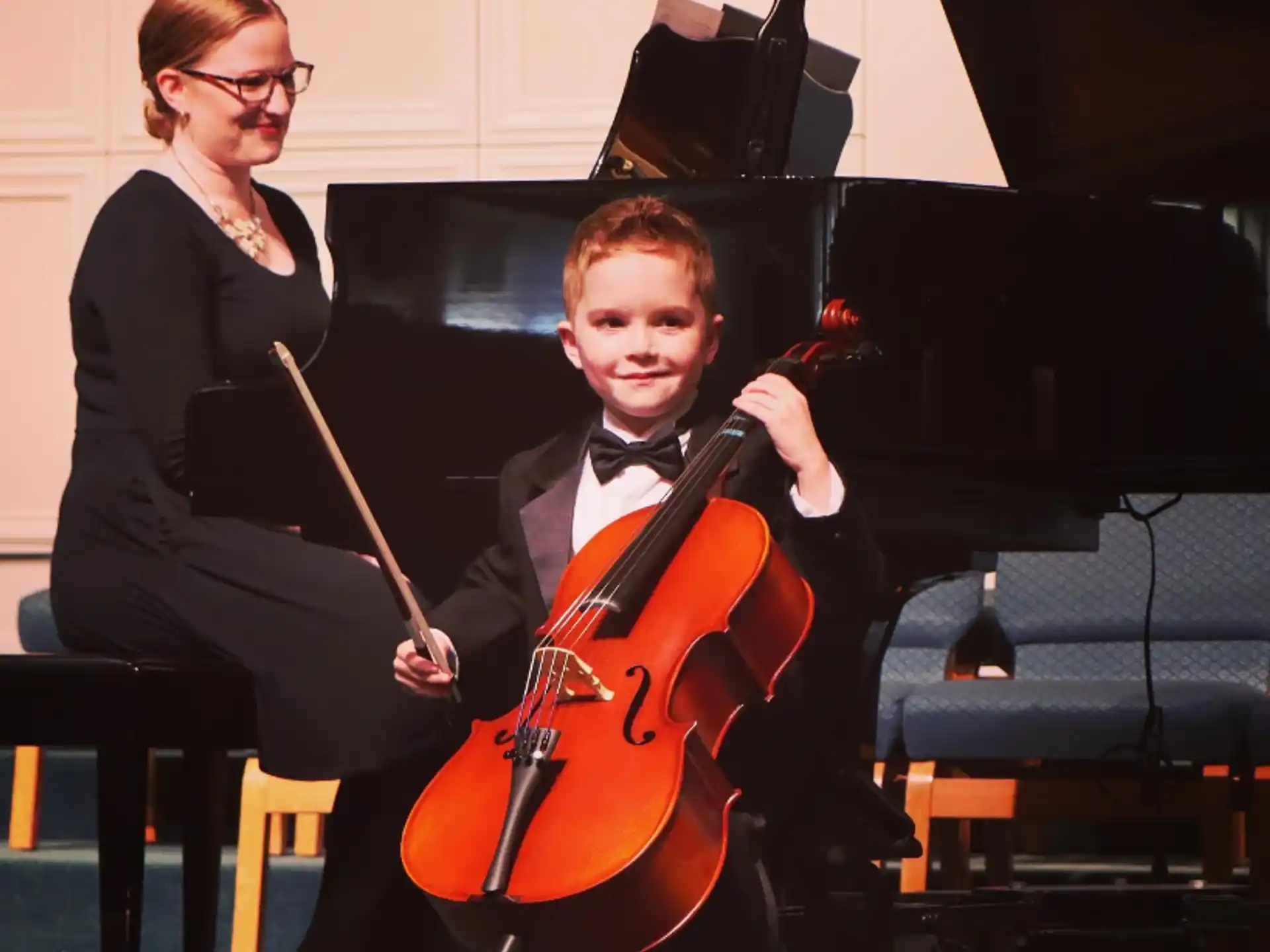 a boy playing a violin